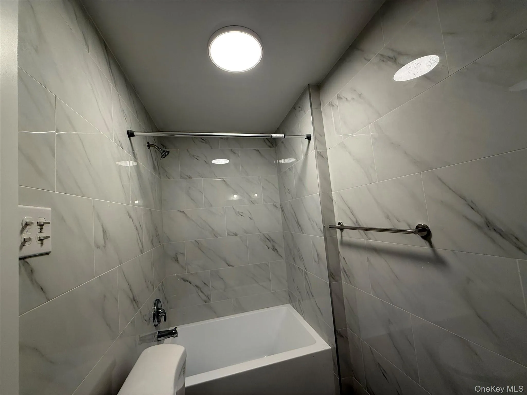 Full bathroom with shower / bathtub combination and toilet Full bathroom with shower / bathtub combination and toilet