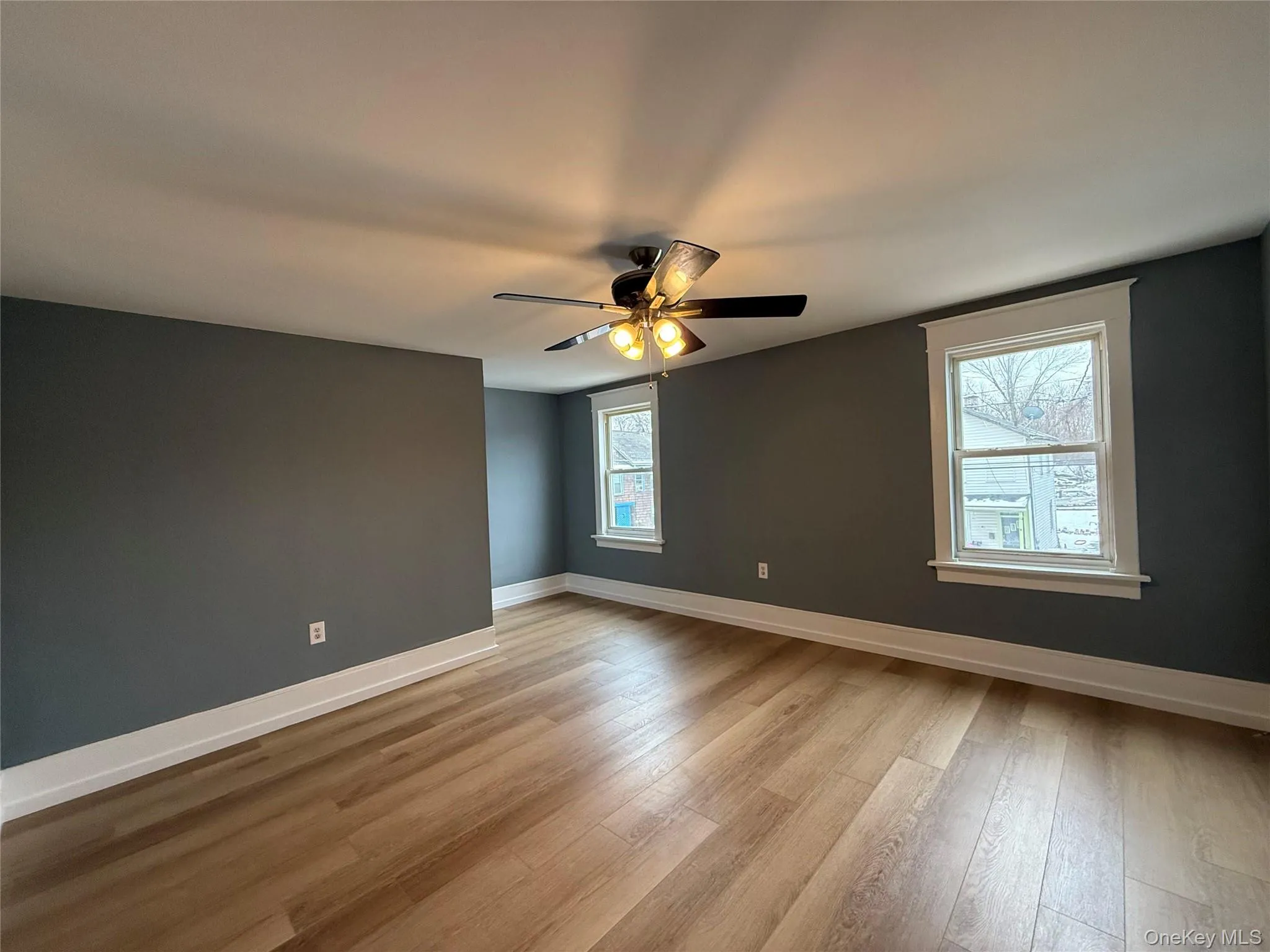 Spare room featuring light wood-style flooring and a ceiling fan Spare room featuring light wood-style flooring and a ceiling fan