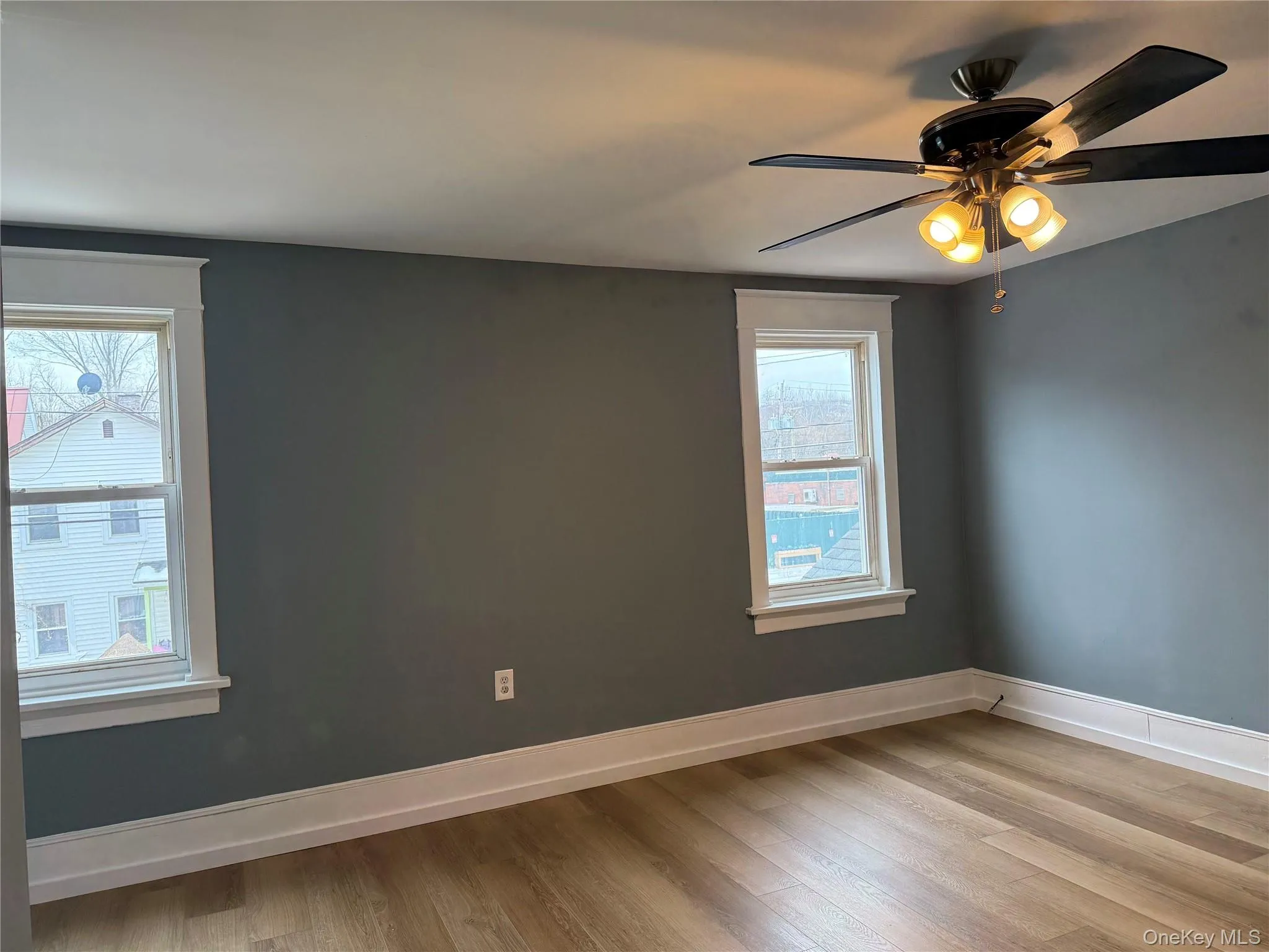 Empty room featuring a ceiling fan and light wood finished floors Empty room featuring a ceiling fan and light wood finished floors