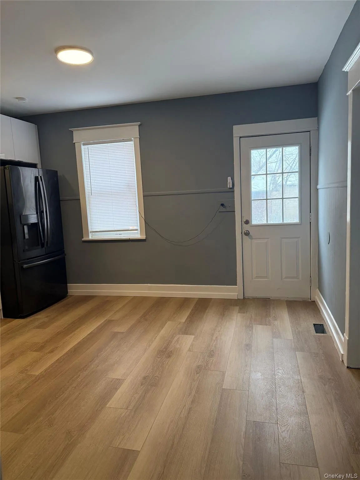 Doorway with wood finished floors and baseboards Doorway with wood finished floors and baseboards