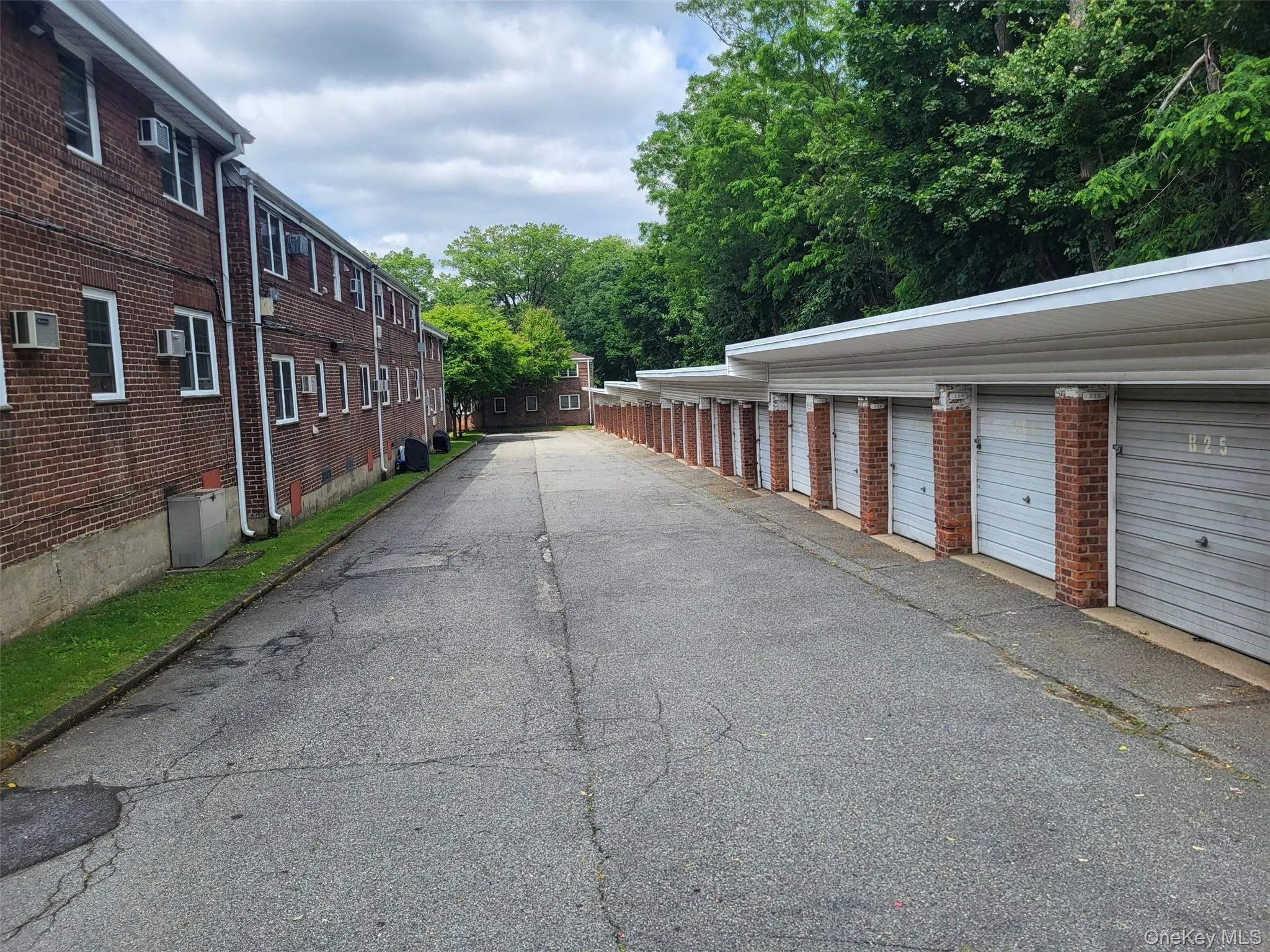 View of asphalt road with community garages View of asphalt road with community garages