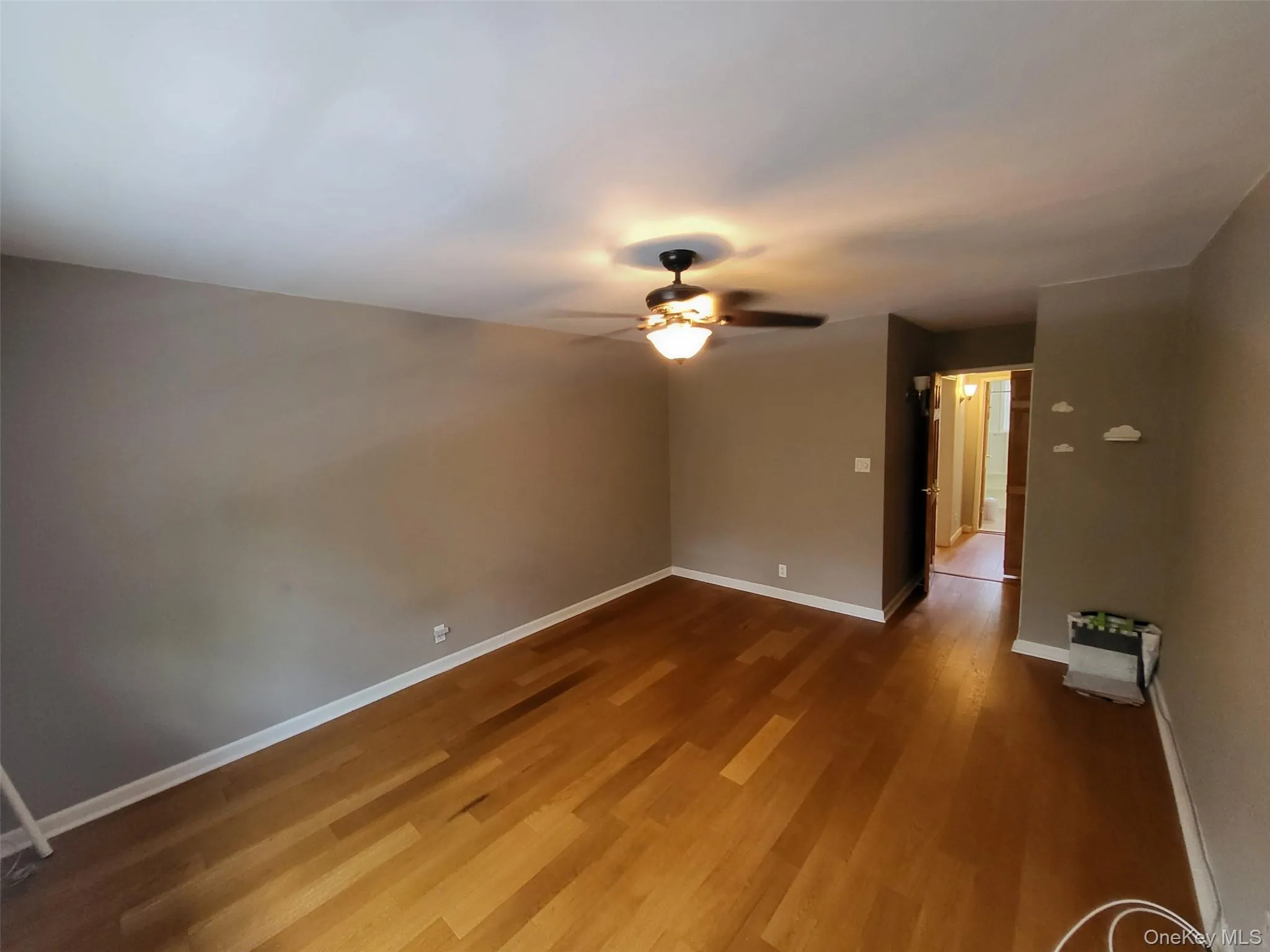 Empty room featuring ceiling fan and wood finished floors Empty room featuring ceiling fan and wood finished floors