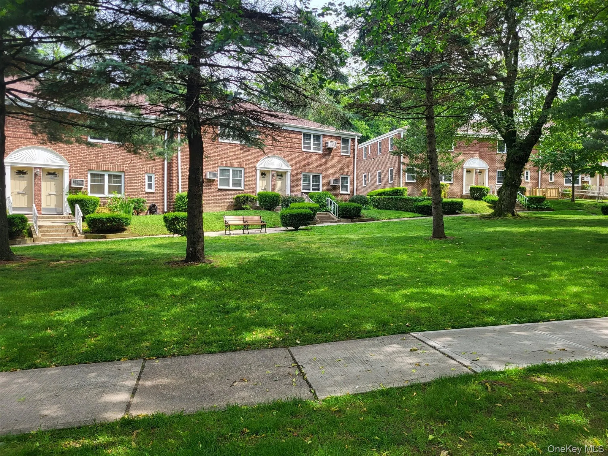 View of property's community featuring a yard View of property's community featuring a yard