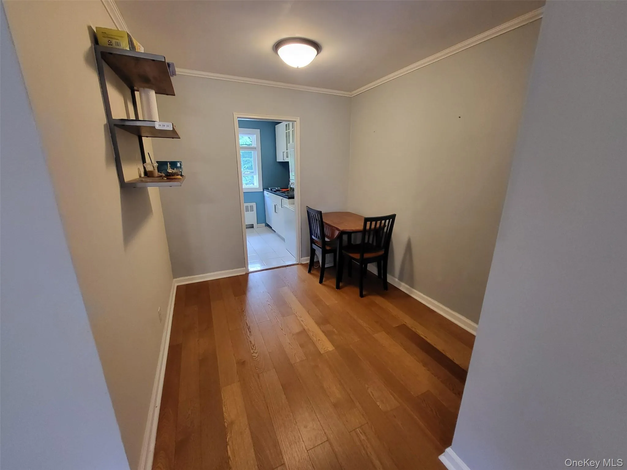 Dining area featuring wood-type flooring and ornamental molding Dining area featuring wood-type flooring and ornamental molding