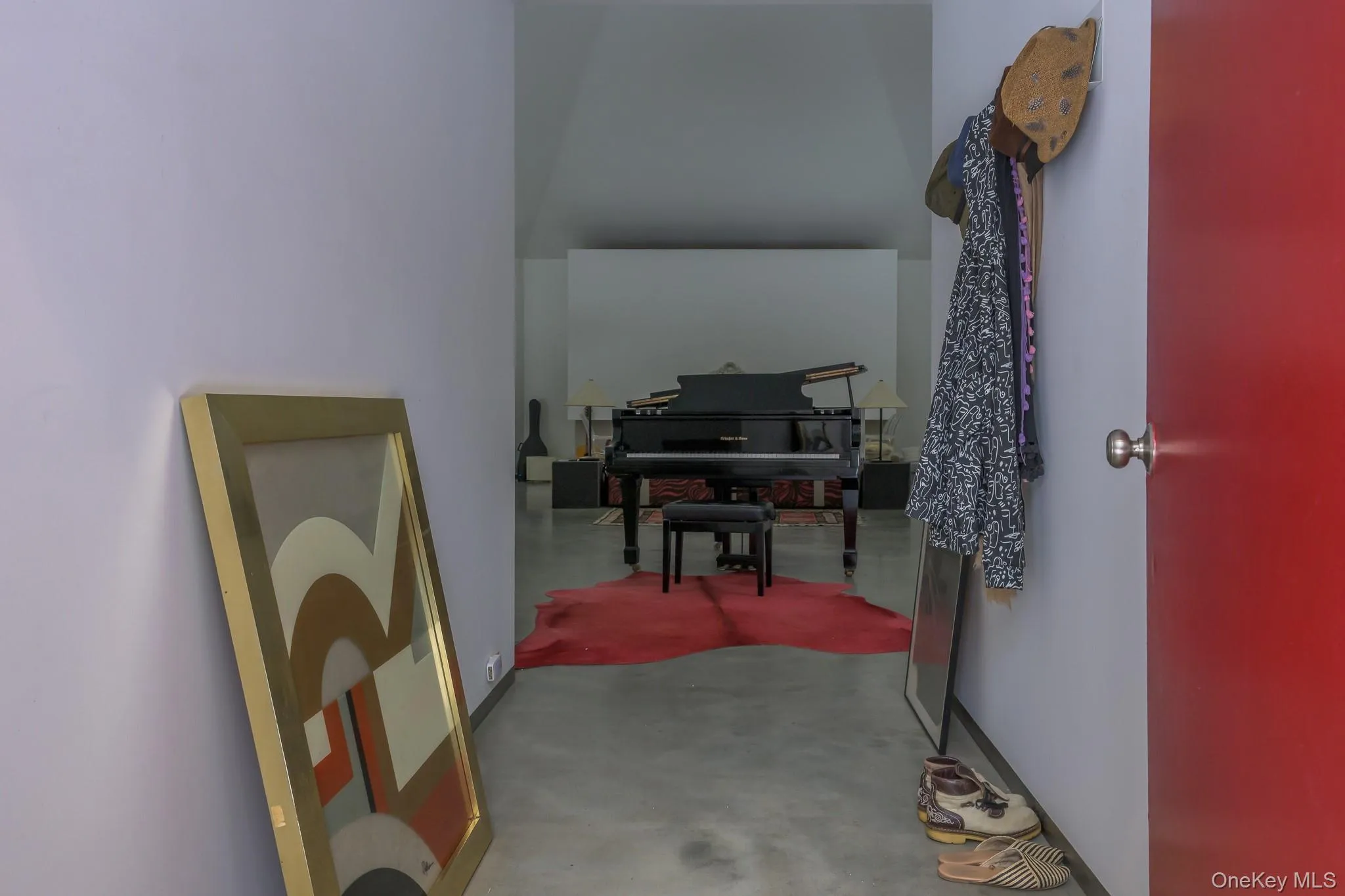 Hallway with concrete flooring and baseboards Hallway with concrete flooring and baseboards