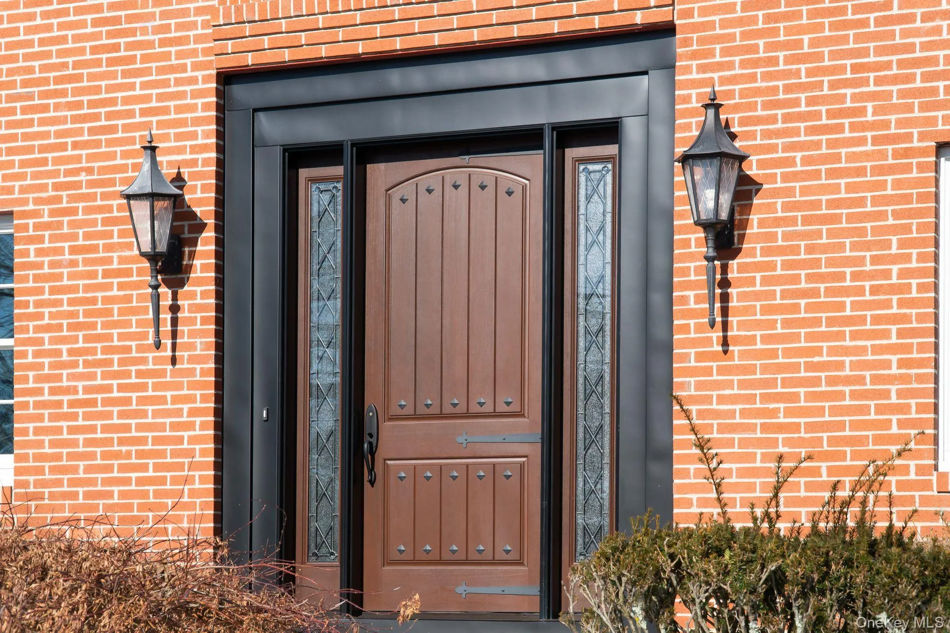 Doorway to property featuring brick siding Doorway to property featuring brick siding