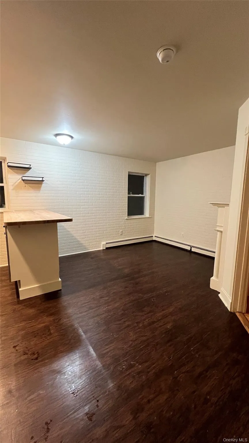 Unfurnished living room with dark wood finished floors Unfurnished living room with dark wood finished floors