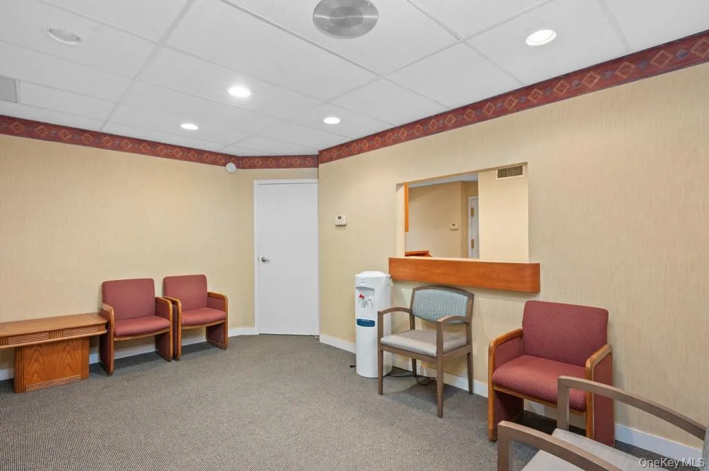 Sitting room with a paneled ceiling and recessed lighting Sitting room with a paneled ceiling and recessed lighting