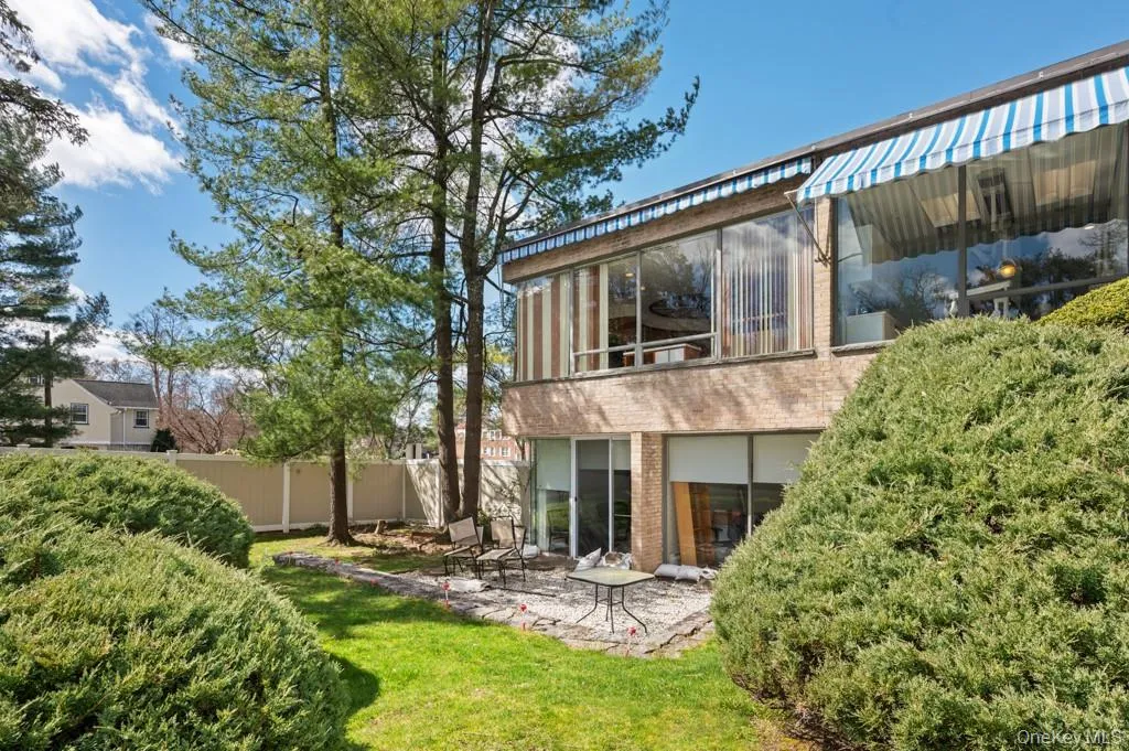Rear view of property with brick siding, a sunroom, a balcony, and a patio Rear view of property with brick siding, a sunroom, a balcony, and a patio