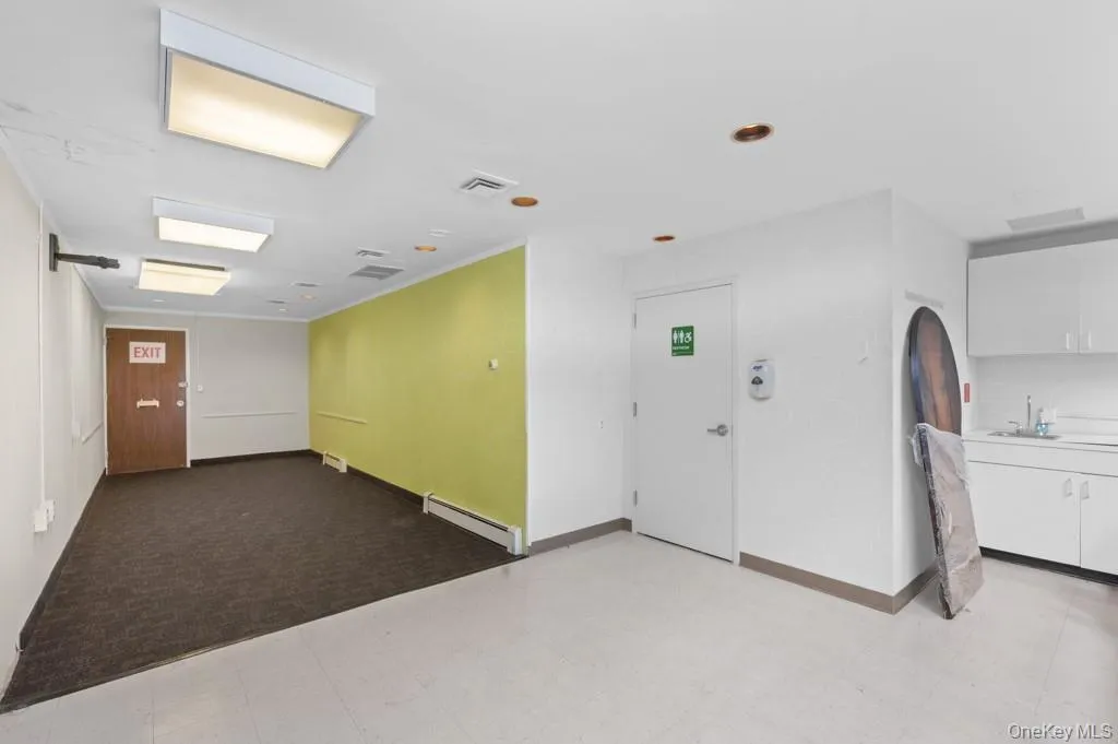 Miscellaneous room with baseboard heating and a sink Miscellaneous room with baseboard heating and a sink