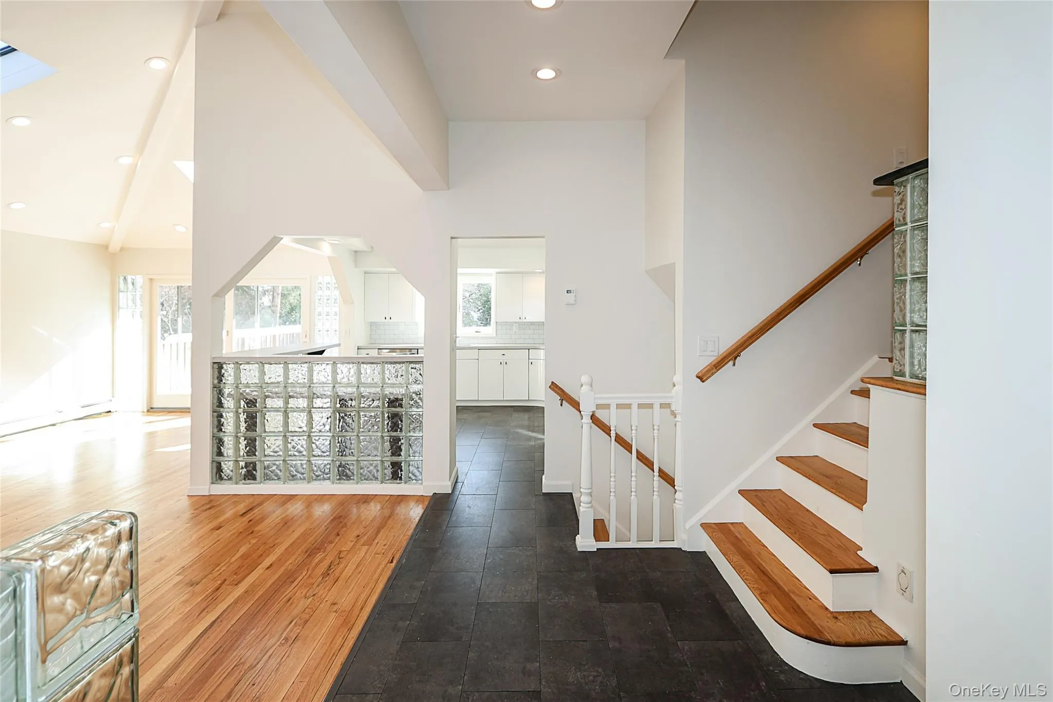 Entryway featuring recessed lighting, dark wood finished floors, lofted ceiling, and stairway Entryway featuring recessed lighting, dark wood finished floors, lofted ceiling, and stairway