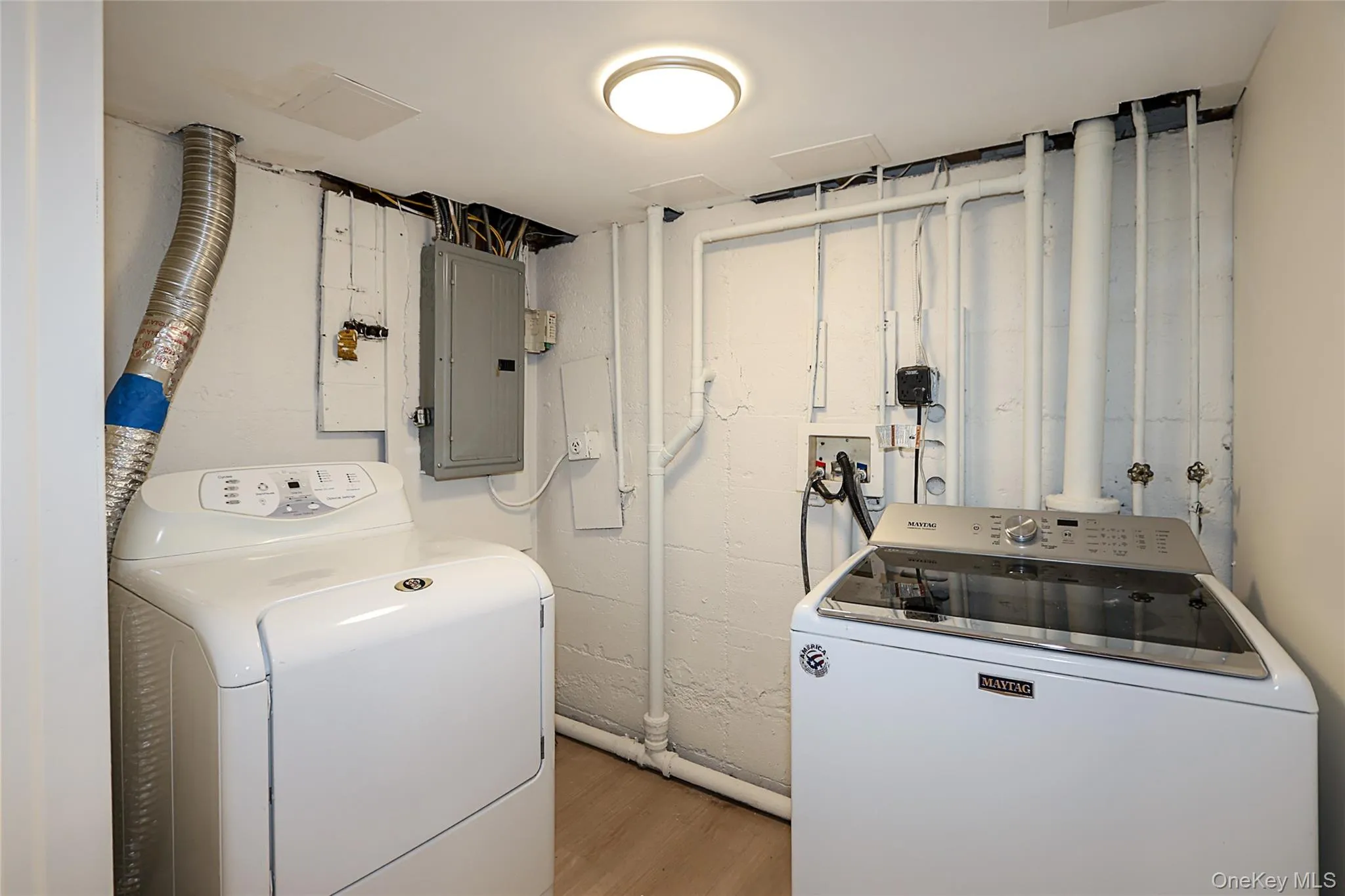 Washroom with electric panel and washer and clothes dryer Washroom with electric panel and washer and clothes dryer