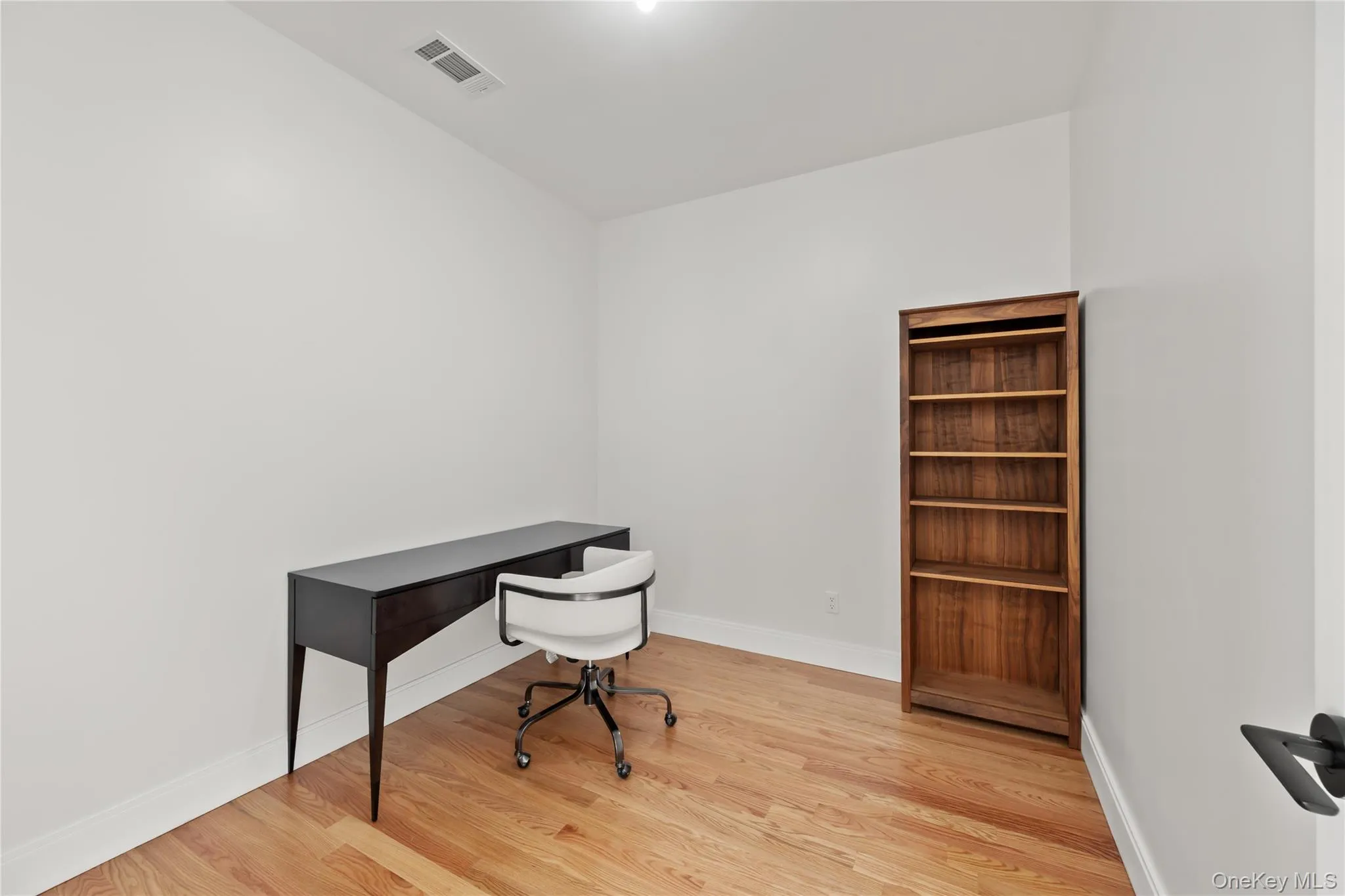 Office area featuring light wood-type flooring and baseboards Office area featuring light wood-type flooring and baseboards