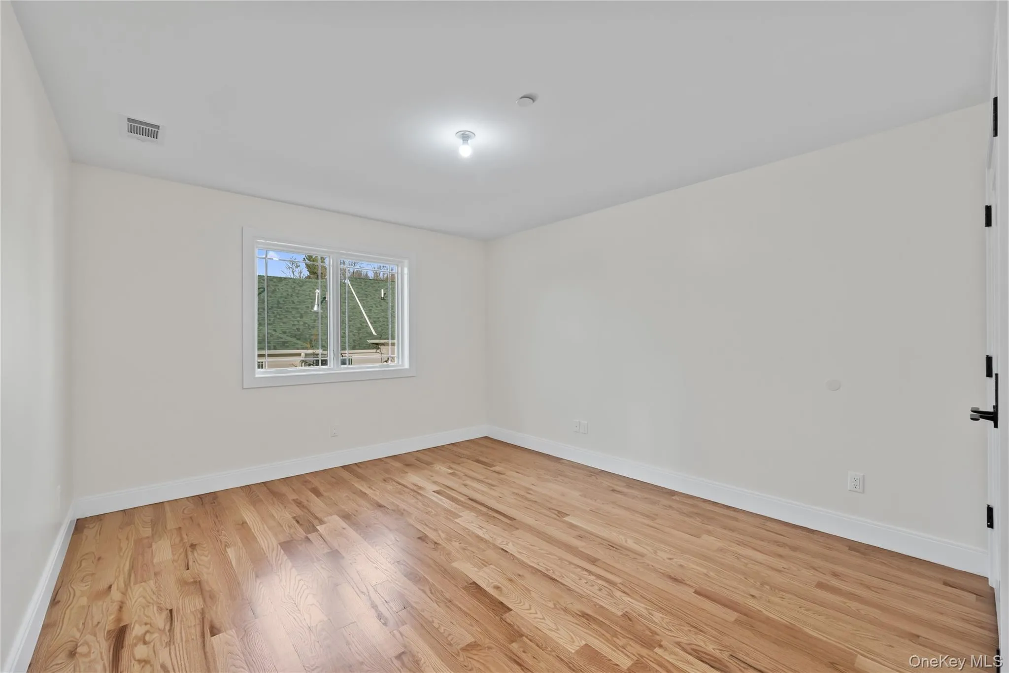 Unfurnished room featuring light wood finished floors and baseboards Unfurnished room featuring light wood finished floors and baseboards