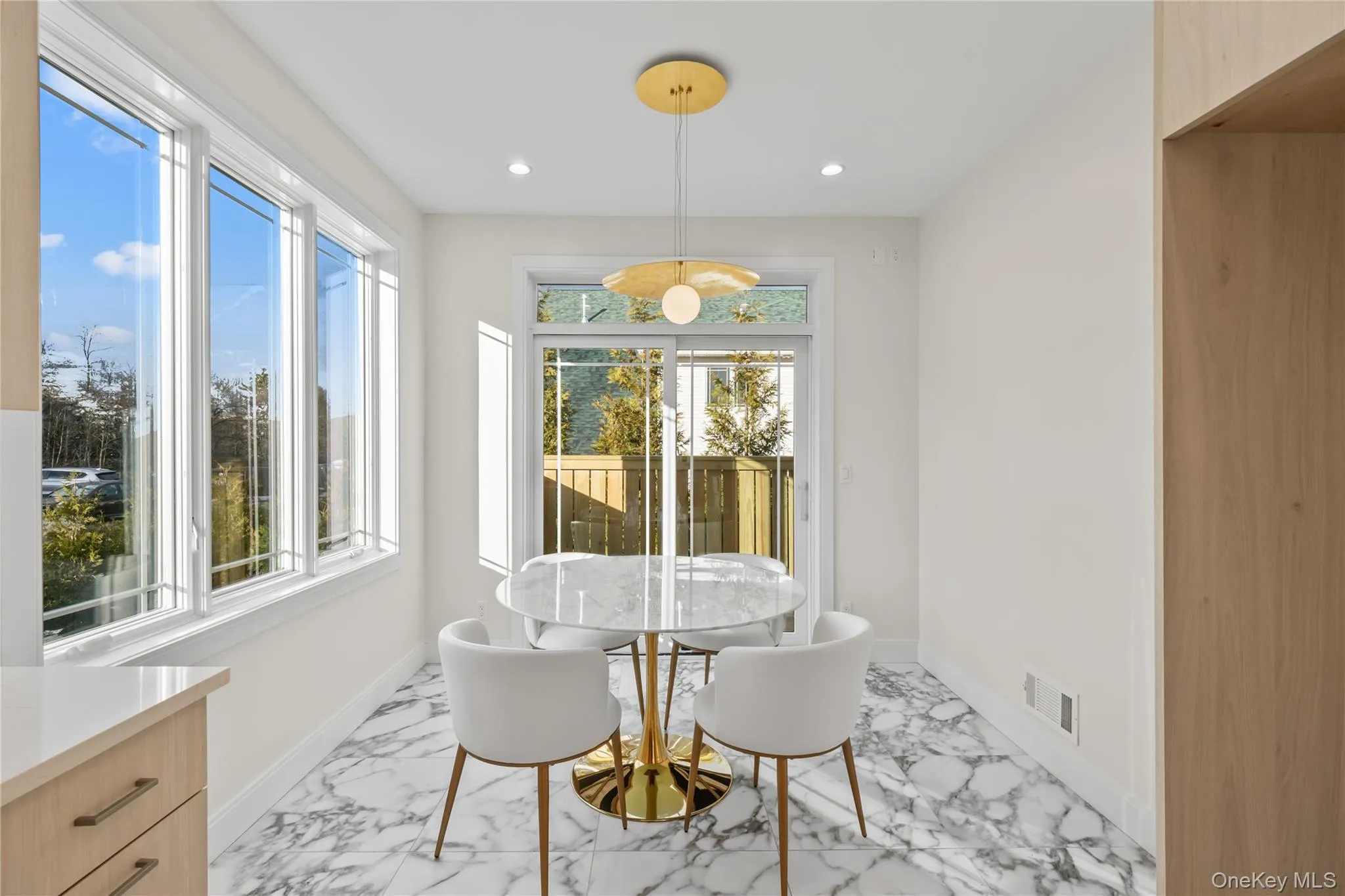 Dining area featuring light marble finish flooring, recessed lighting, and plenty of natural light Dining area featuring light marble finish flooring, recessed lighting, and plenty of natural light