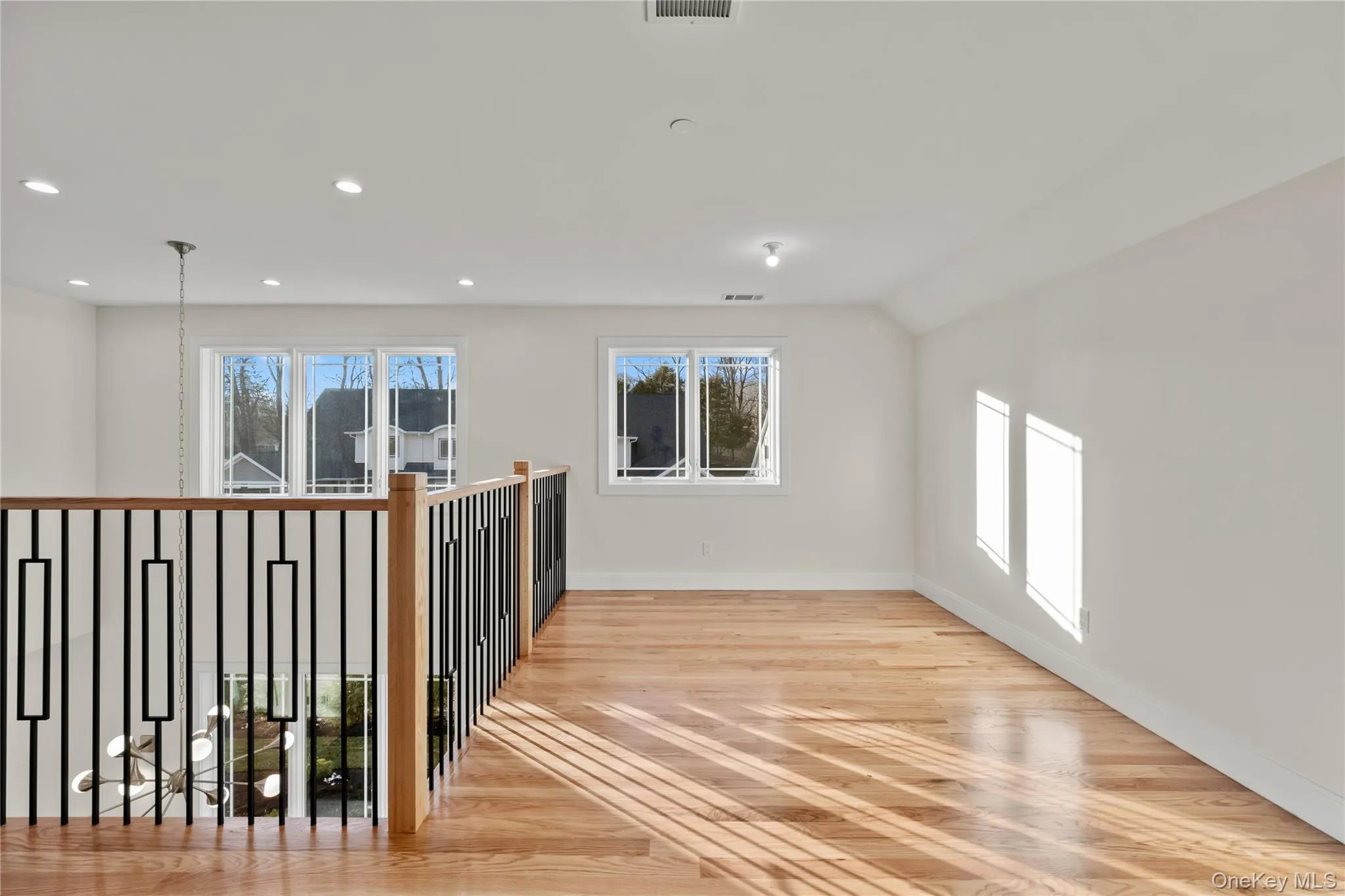 Spare room with light wood finished floors and recessed lighting Spare room with light wood finished floors and recessed lighting