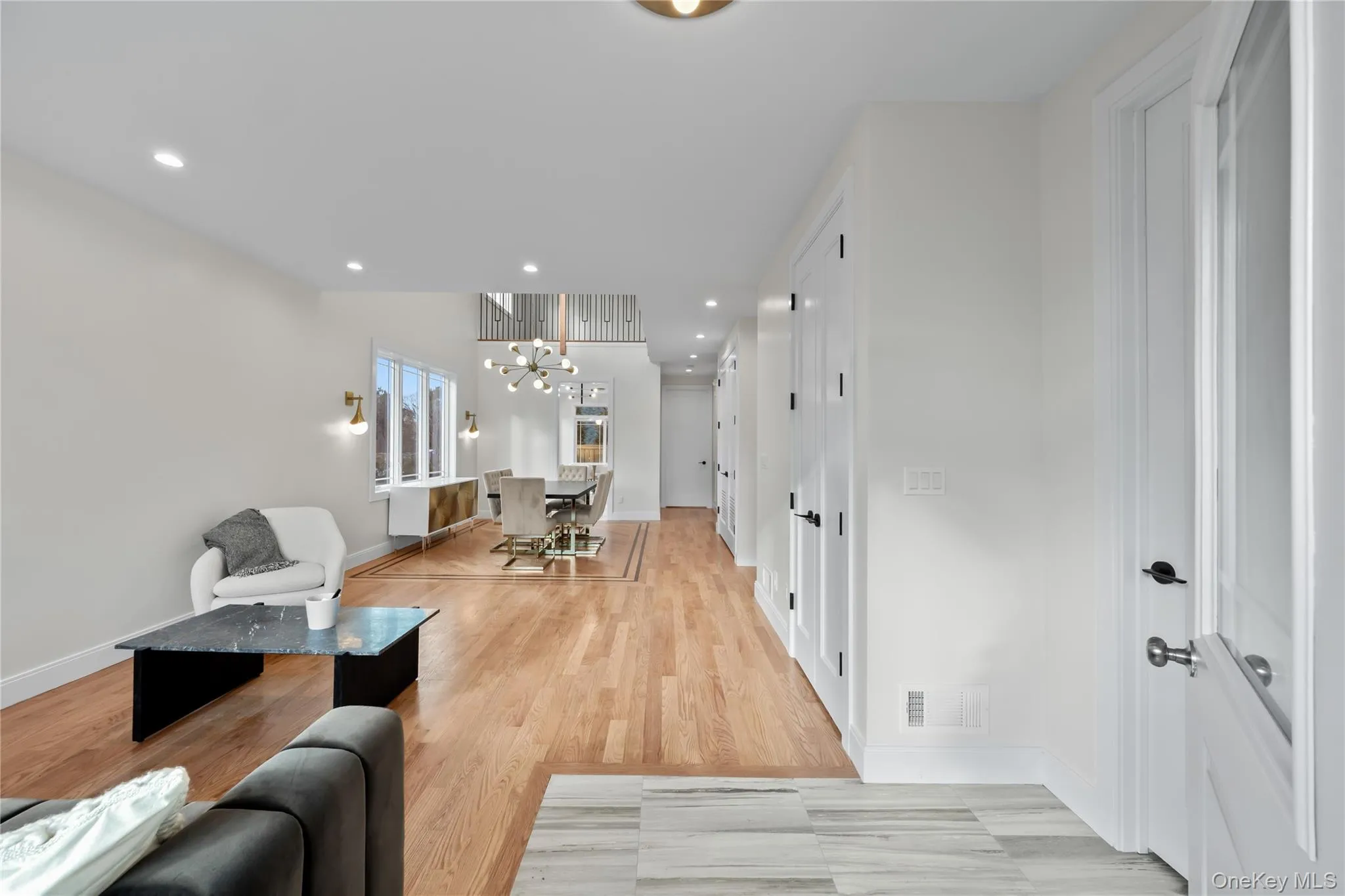 Living area featuring recessed lighting, a chandelier, and light wood finished floors Living area featuring recessed lighting, a chandelier, and light wood finished floors