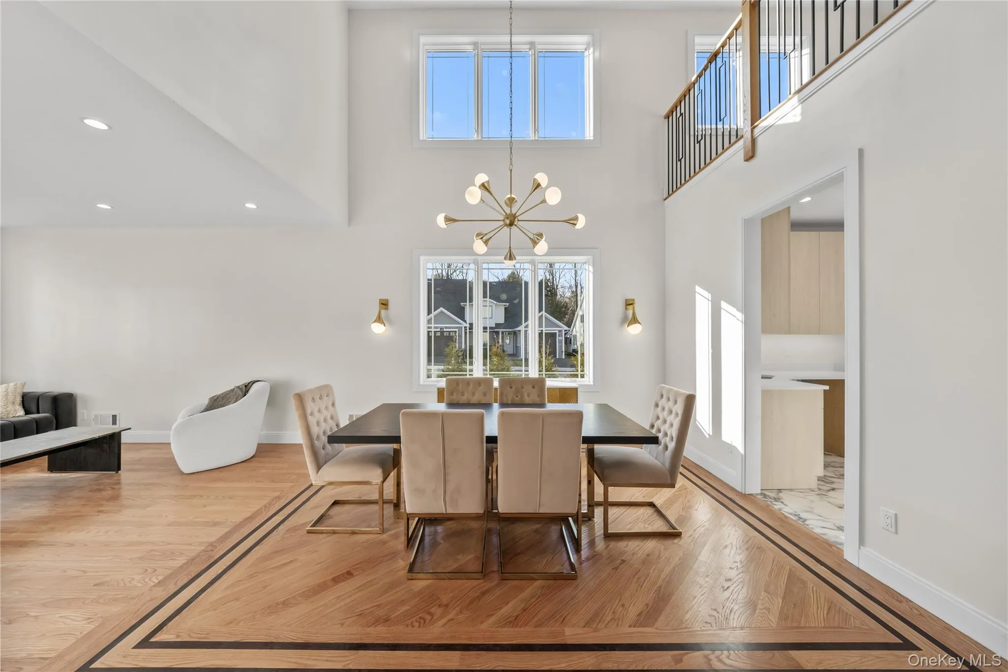 Dining room with recessed lighting, light wood-type flooring, a chandelier, and a high ceiling Dining room with recessed lighting, light wood-type flooring, a chandelier, and a high ceiling