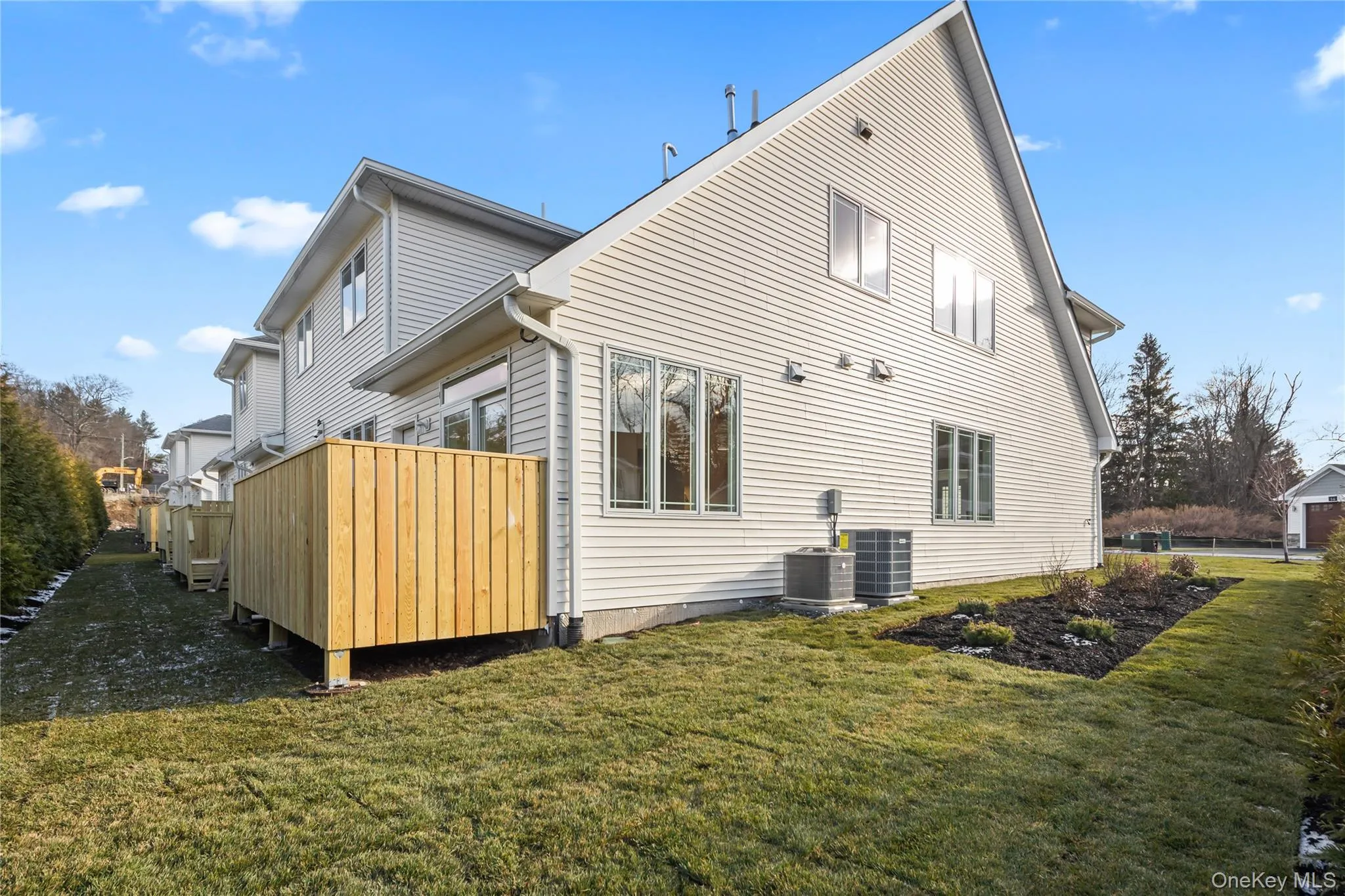 Back of house featuring a yard and a deck Back of house featuring a yard and a deck