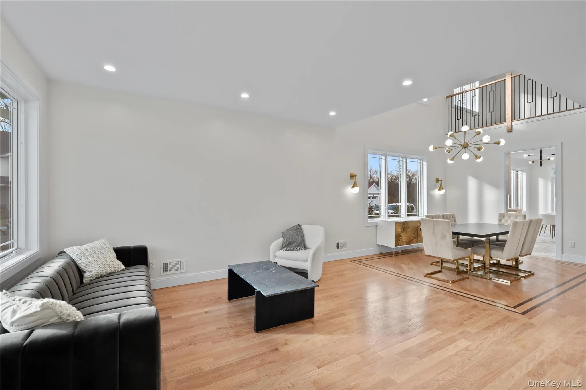 Living room with light wood finished floors, recessed lighting, and a chandelier Living room with light wood finished floors, recessed lighting, and a chandelier
