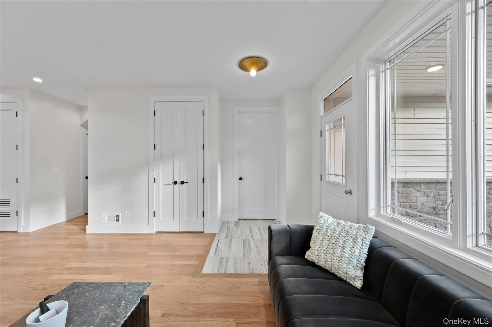Living room with recessed lighting and light wood-style floors Living room with recessed lighting and light wood-style floors