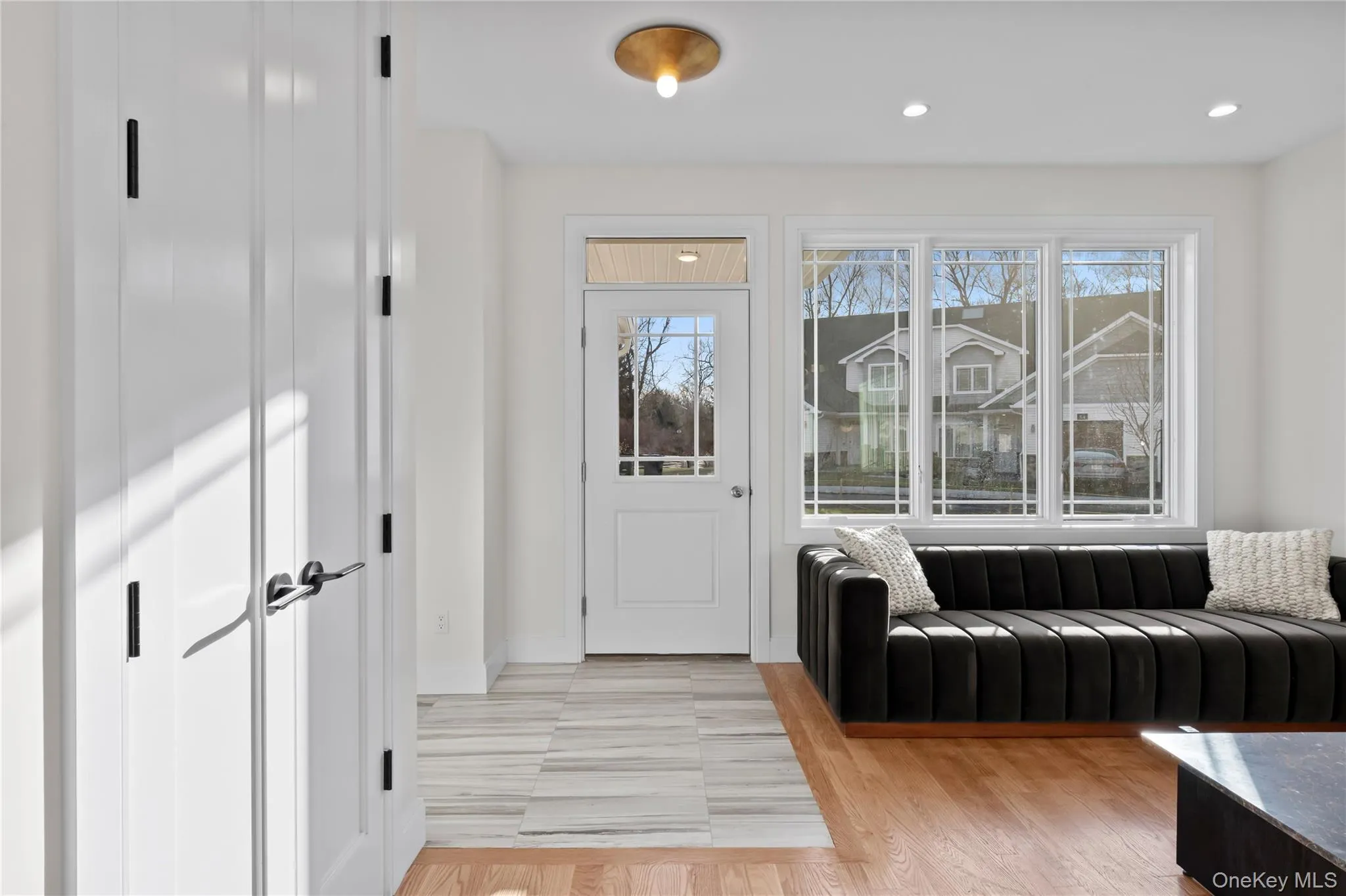Foyer entrance with light wood-style flooring and recessed lighting Foyer entrance with light wood-style flooring and recessed lighting