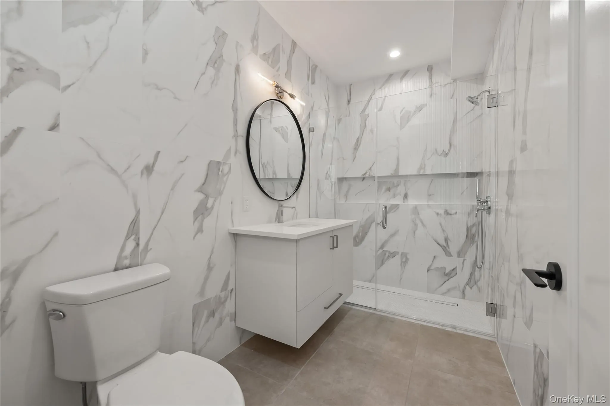 Bathroom with vanity and a marble finish shower Bathroom with vanity and a marble finish shower