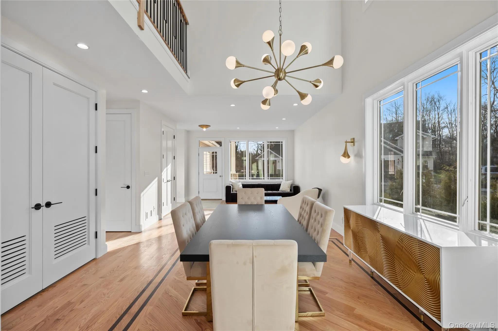 Dining space with recessed lighting, a chandelier, light wood finished floors, radiator heating unit, and a high ceiling Dining space with recessed lighting, a chandelier, light wood finished floors, radiator heating unit, and a high ceiling