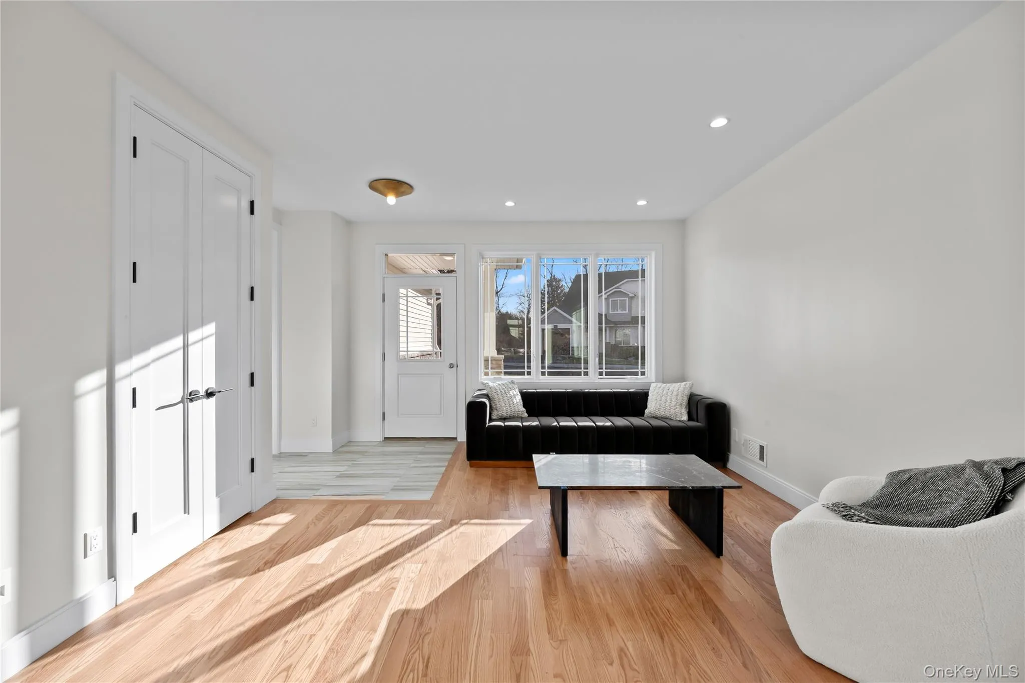 Living area featuring light wood-style flooring and recessed lighting Living area featuring light wood-style flooring and recessed lighting