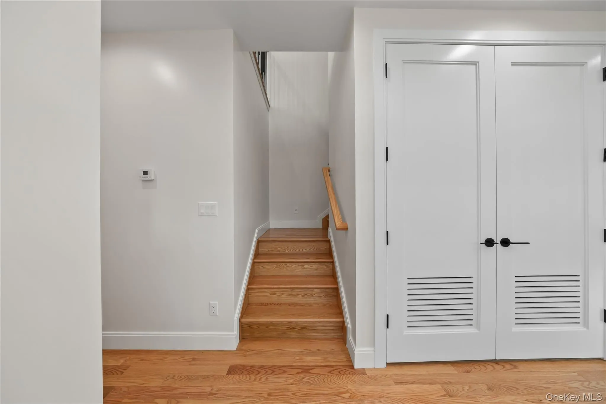 Staircase featuring baseboards and wood finished floors Staircase featuring baseboards and wood finished floors