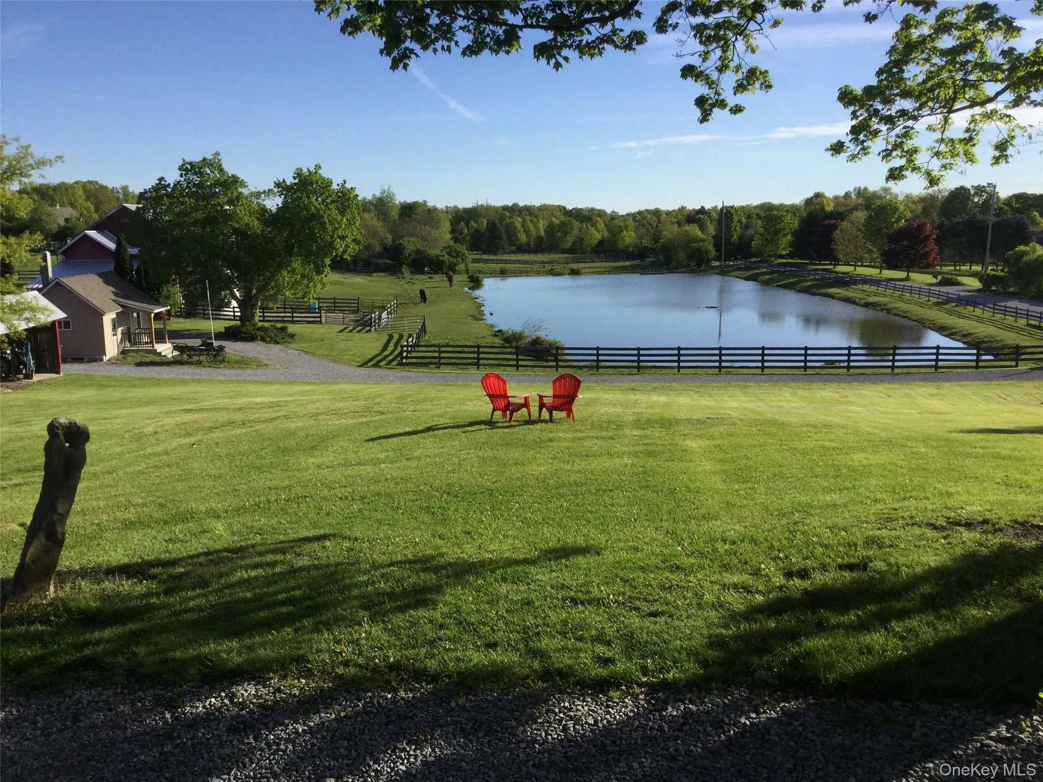 View of community featuring an enclosed horse arena, a water view, and a rural view View of community featuring an enclosed horse arena, a water view, and a rural view