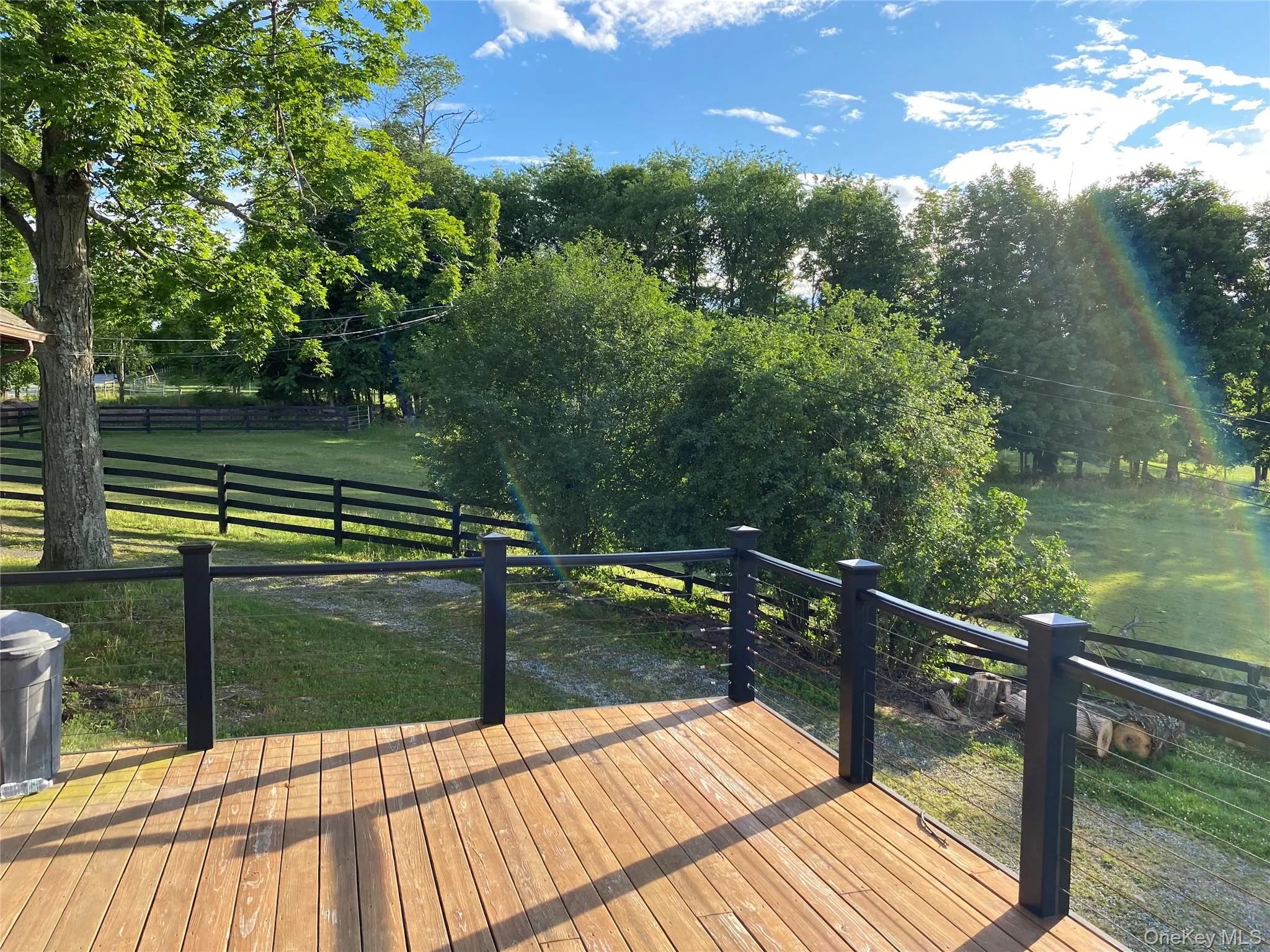 Wooden deck featuring a view of rural / pastoral area Wooden deck featuring a view of rural / pastoral area