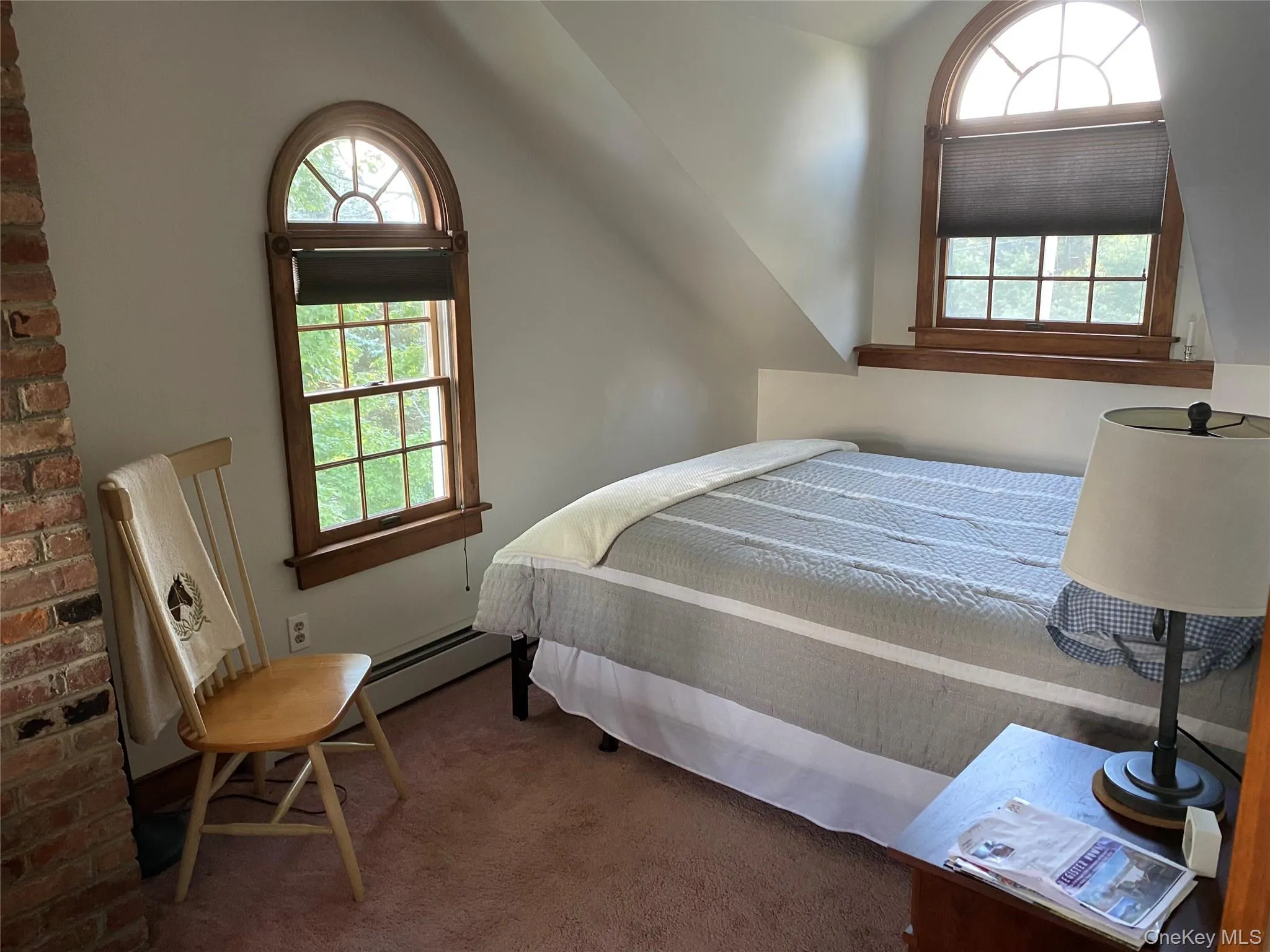 Bedroom featuring carpet, a baseboard heating unit, and lofted ceiling Bedroom featuring carpet, a baseboard heating unit, and lofted ceiling