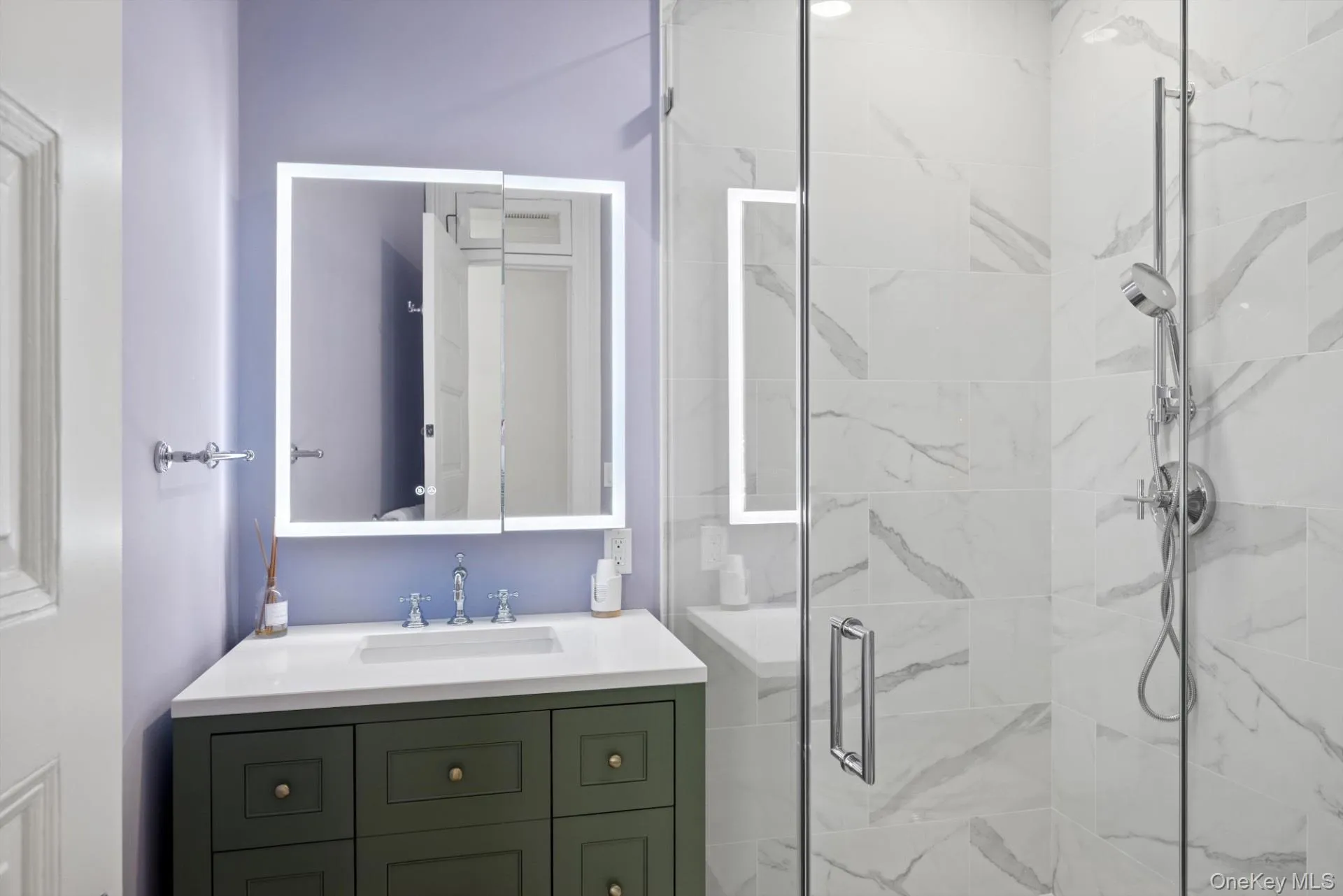 Full bath with a marble finish shower and vanity Full bath with a marble finish shower and vanity