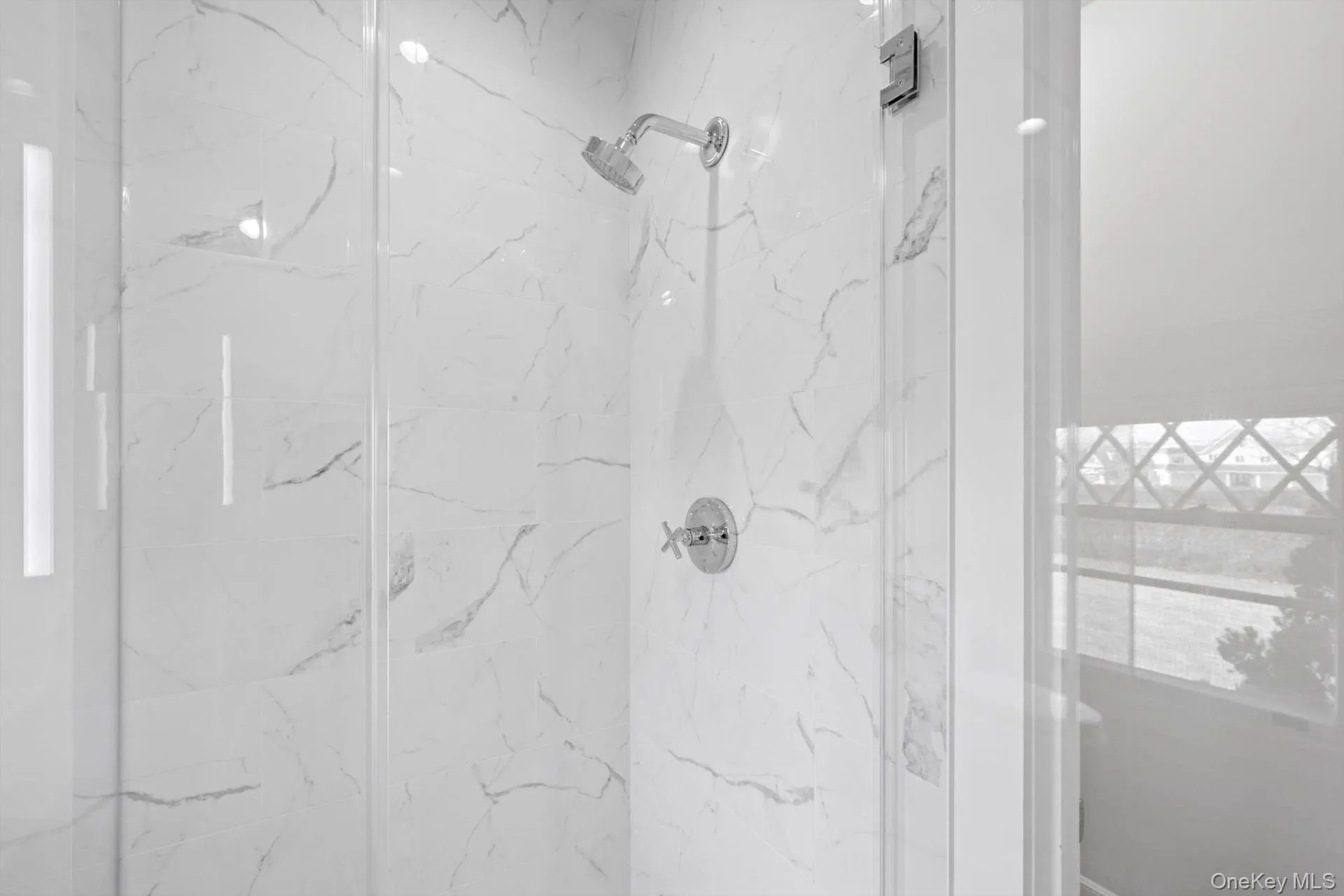 Bathroom featuring a marble finish shower Bathroom featuring a marble finish shower