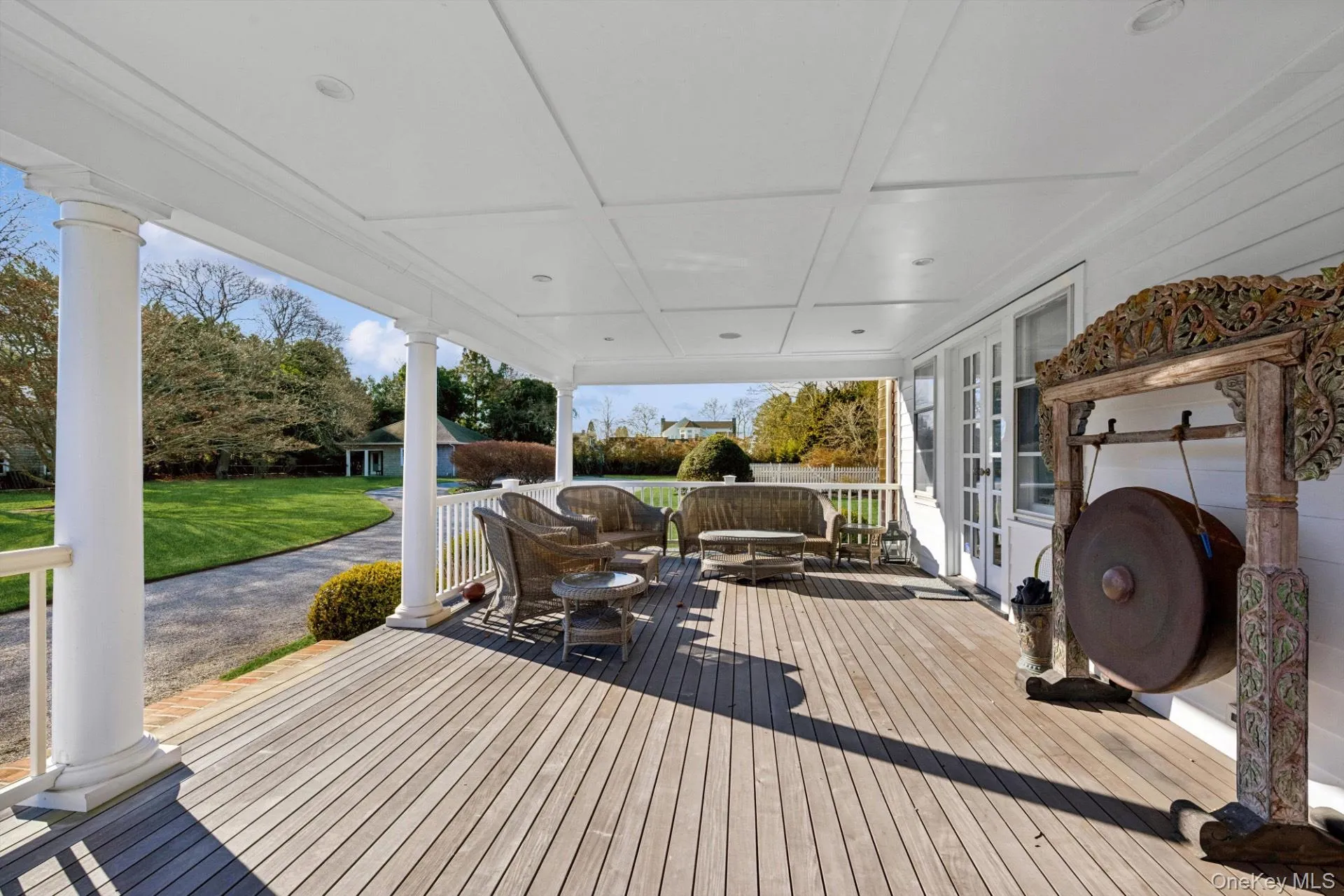Wooden terrace with a lawn, french doors, and outdoor dining space Wooden terrace with a lawn, french doors, and outdoor dining space