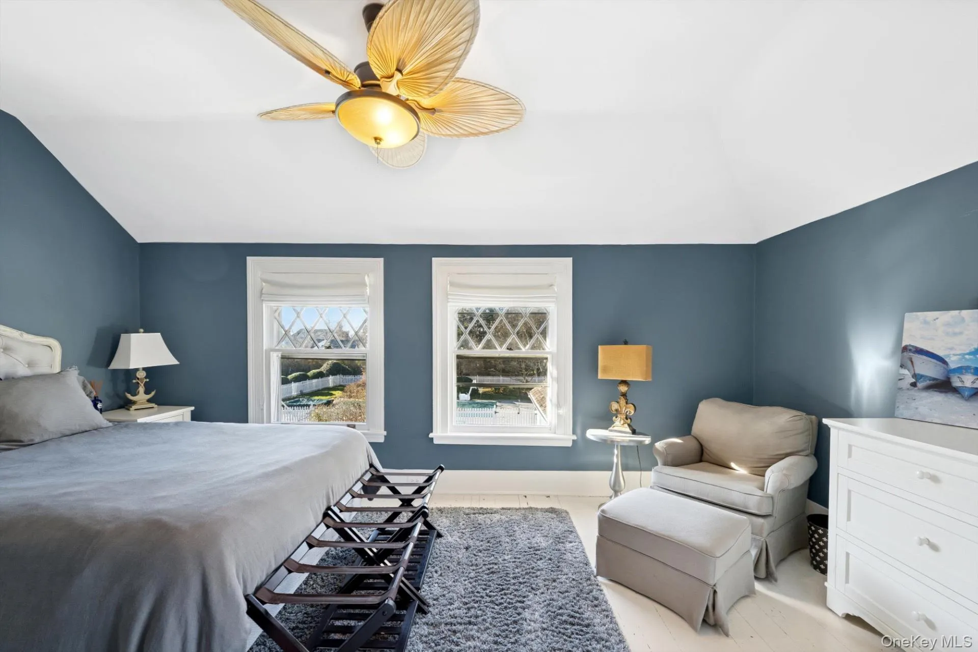 Bedroom featuring vaulted ceiling and a ceiling fan Bedroom featuring vaulted ceiling and a ceiling fan