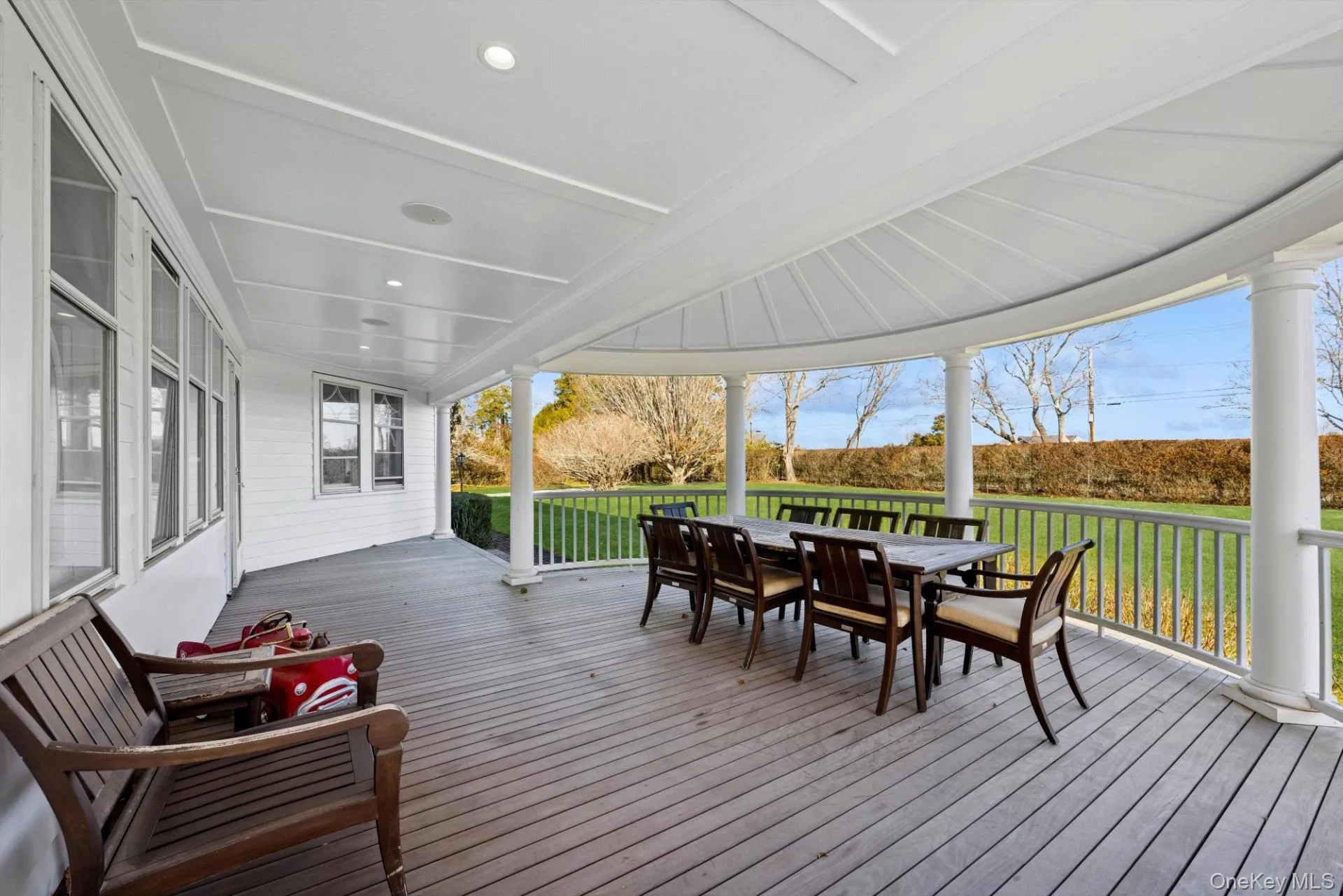 Deck featuring outdoor dining space and a lawn Deck featuring outdoor dining space and a lawn