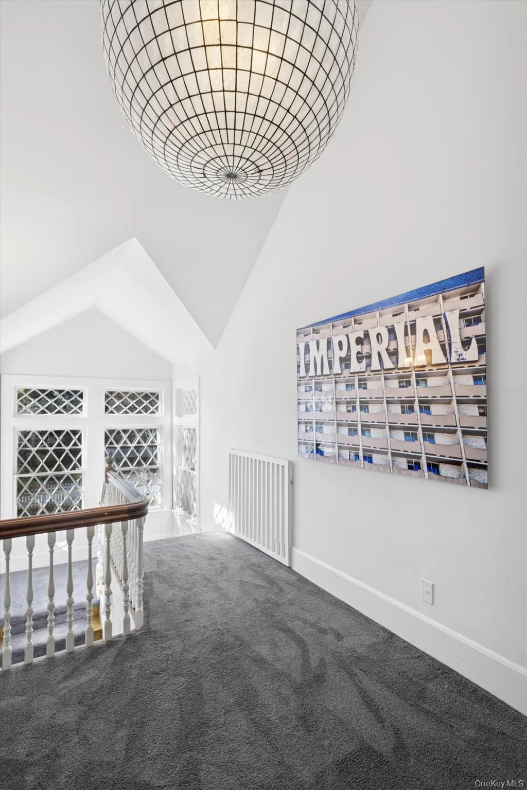 Spare room with carpet floors and high vaulted ceiling Spare room with carpet floors and high vaulted ceiling