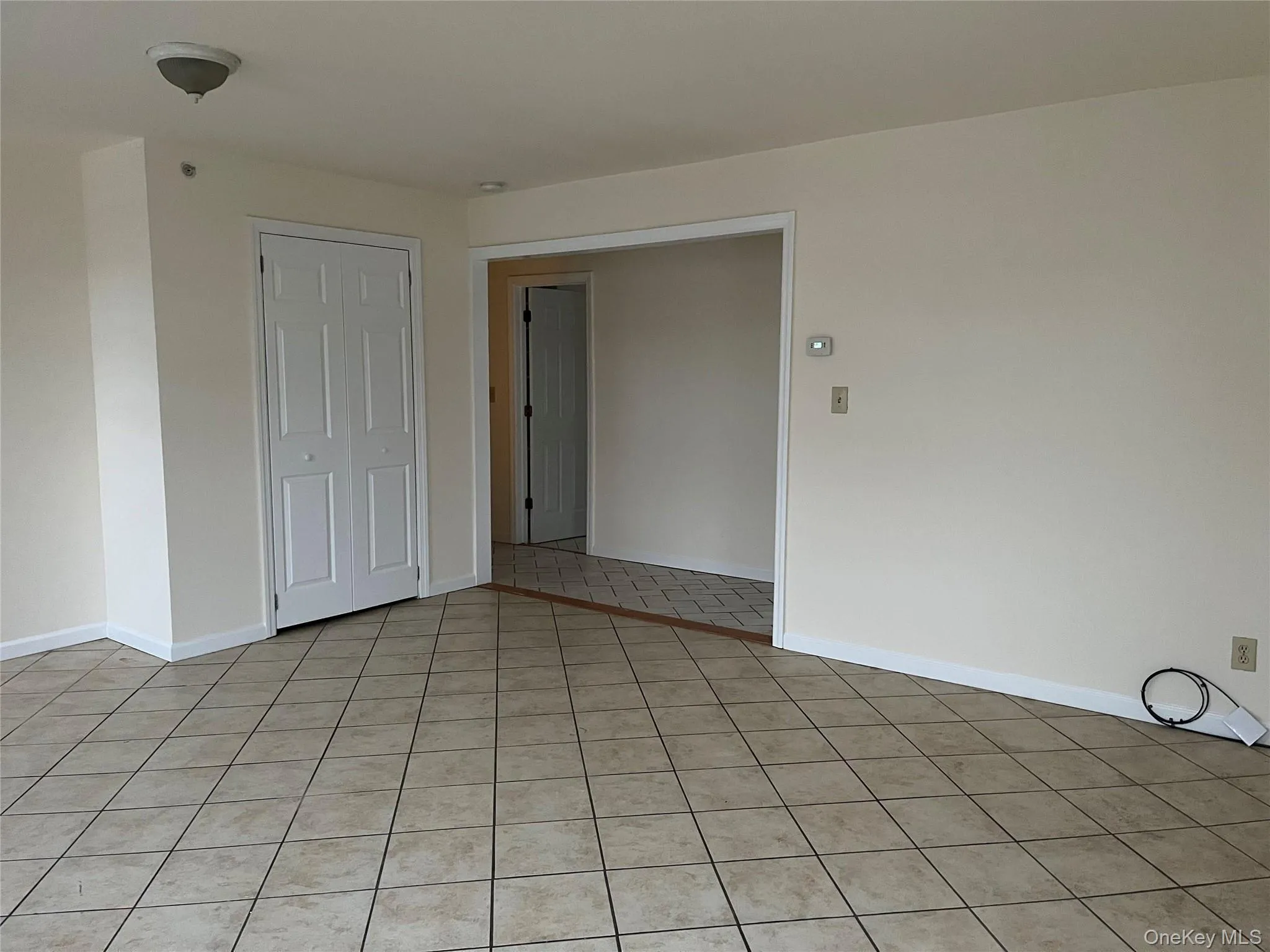 Unfurnished room with light tile patterned flooring Unfurnished room with light tile patterned flooring