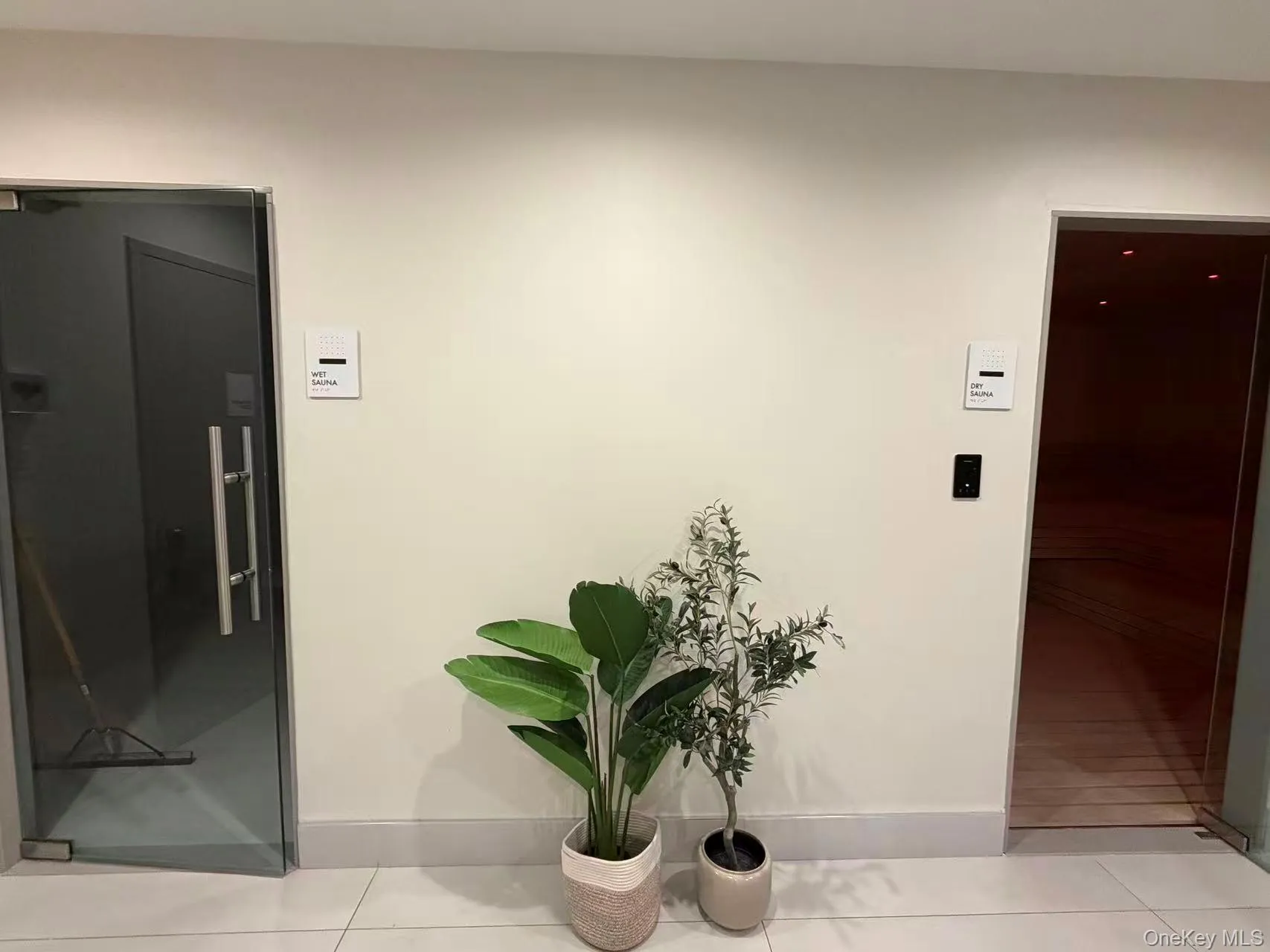 Hallway featuring elevator and light tile patterned floors Hallway featuring elevator and light tile patterned floors