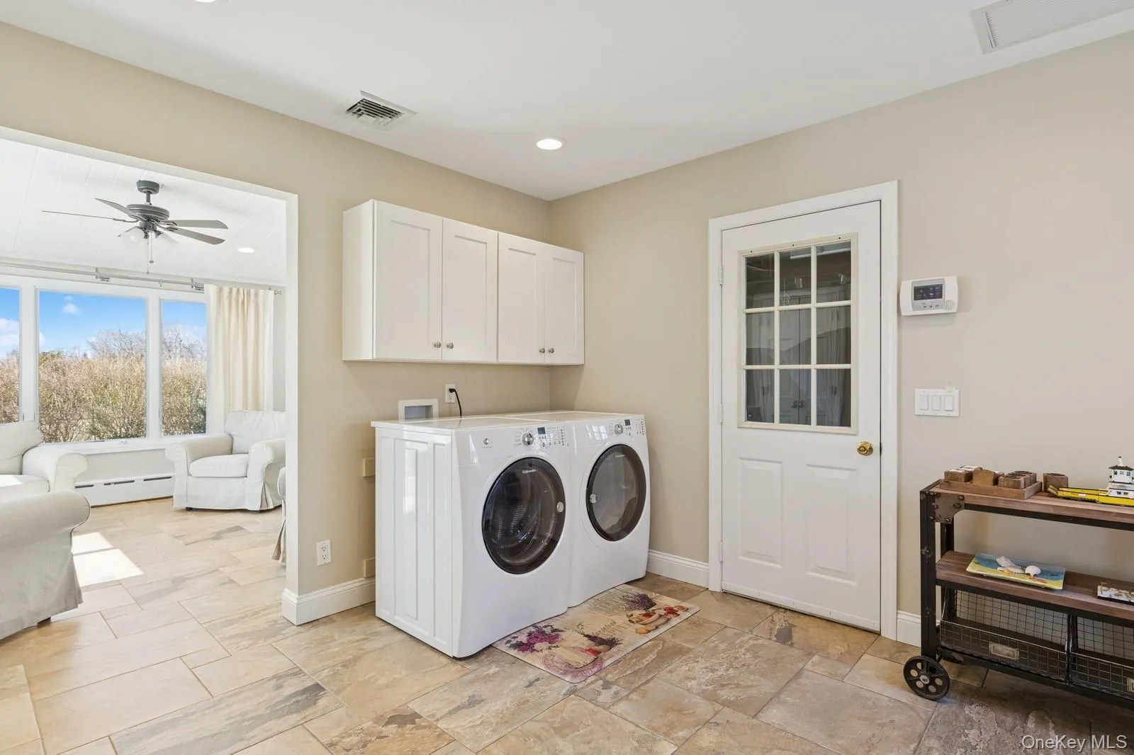 Washroom with a ceiling fan, baseboard heating, washing machine and clothes dryer, and recessed lighting Washroom with a ceiling fan, baseboard heating, washing machine and clothes dryer, and recessed lighting