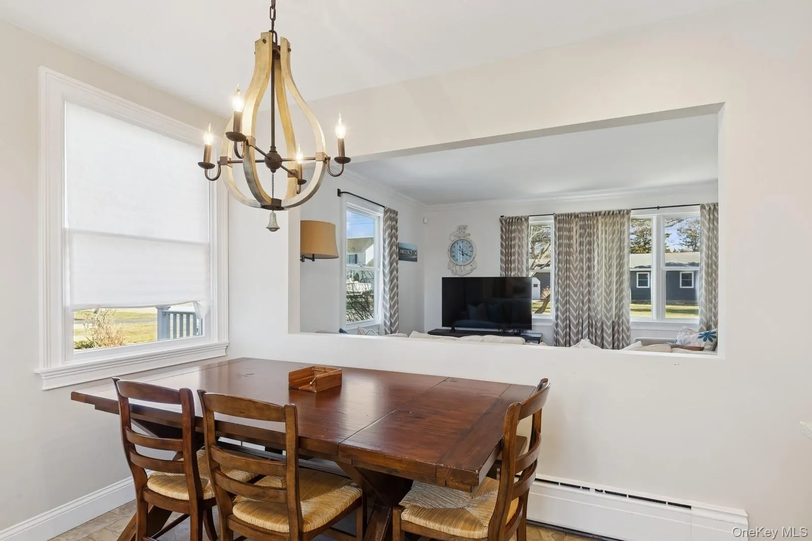 Dining room featuring a baseboard heating unit and a chandelier Dining room featuring a baseboard heating unit and a chandelier