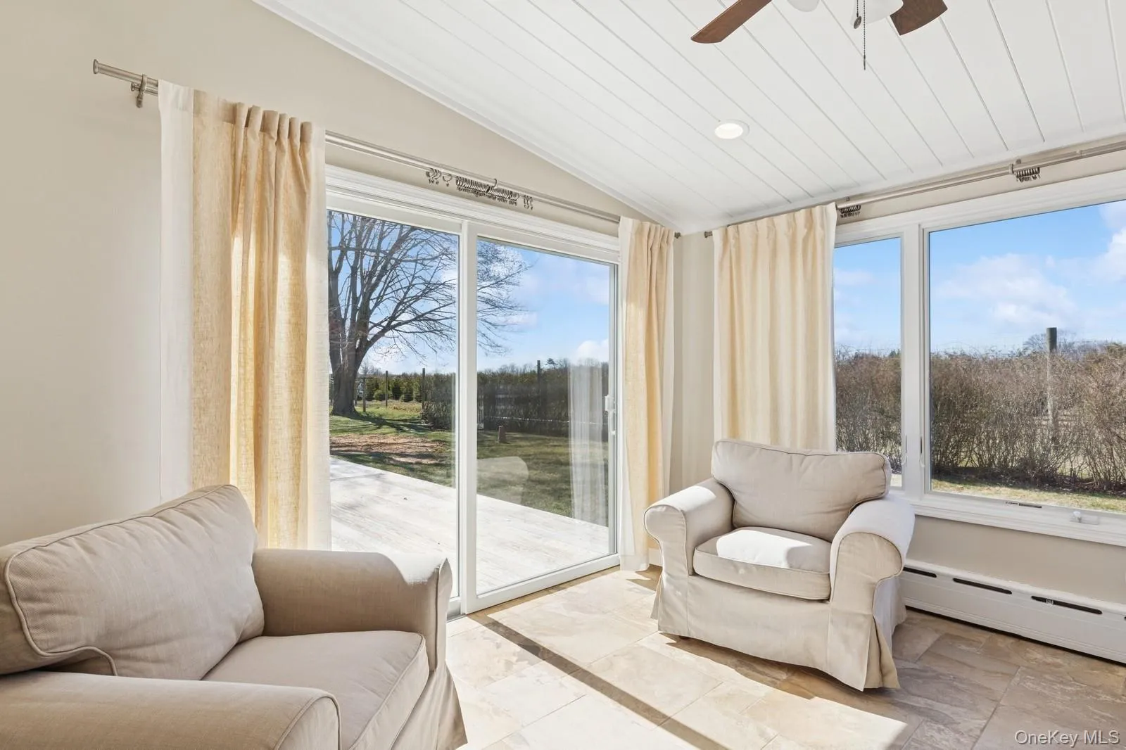 Sunroom / solarium featuring vaulted ceiling, a baseboard heating unit, wooden ceiling, and recessed lighting Sunroom / solarium featuring vaulted ceiling, a baseboard heating unit, wooden ceiling, and recessed lighting
