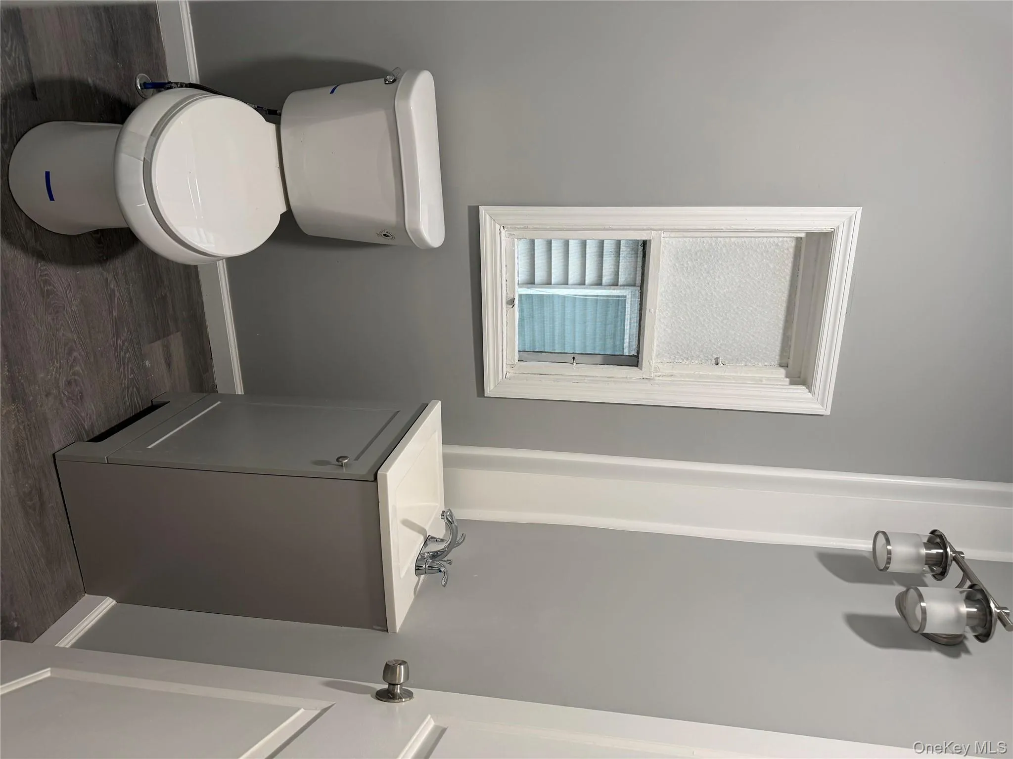 Bathroom with vanity and dark wood-style flooring Bathroom with vanity and dark wood-style flooring