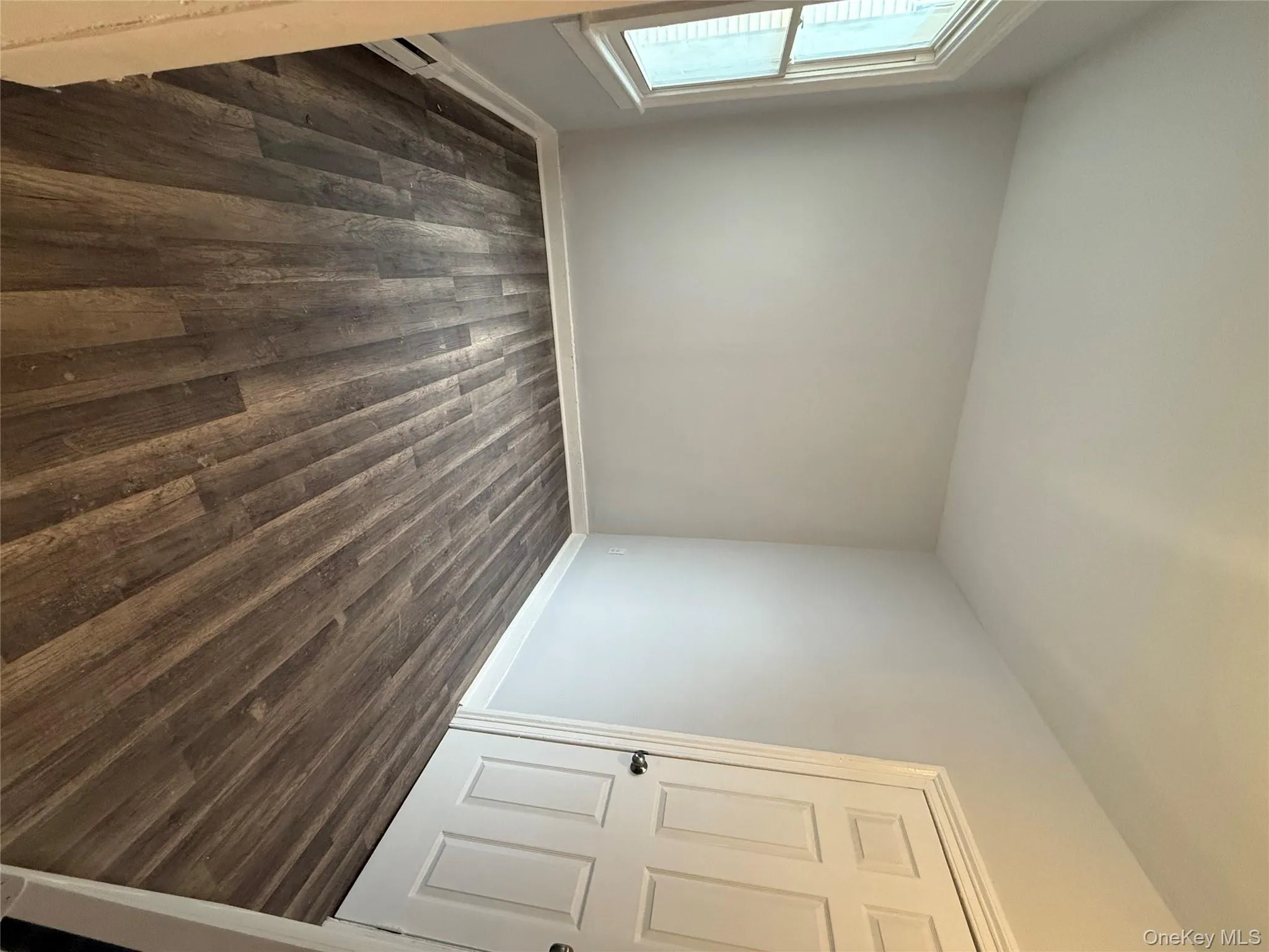 Spare room featuring dark wood finished floors and a baseboard radiator Spare room featuring dark wood finished floors and a baseboard radiator