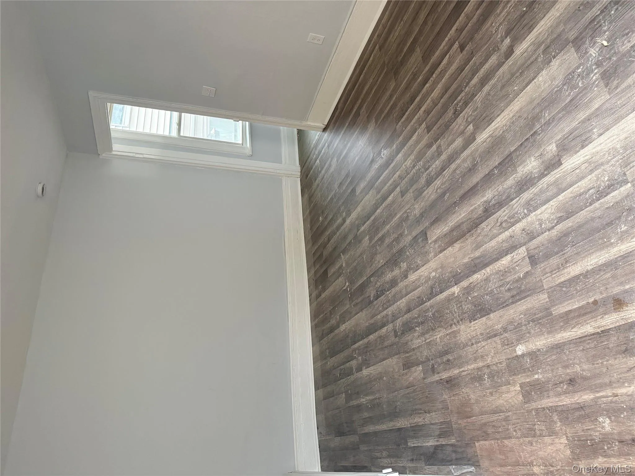 Empty room featuring dark wood-style flooring Empty room featuring dark wood-style flooring