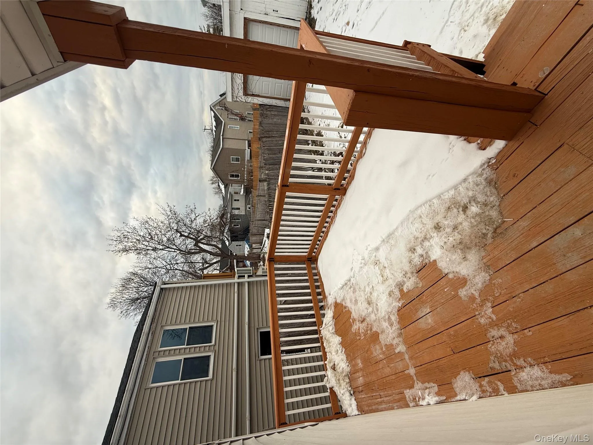 Snow covered deck with a residential view Snow covered deck with a residential view