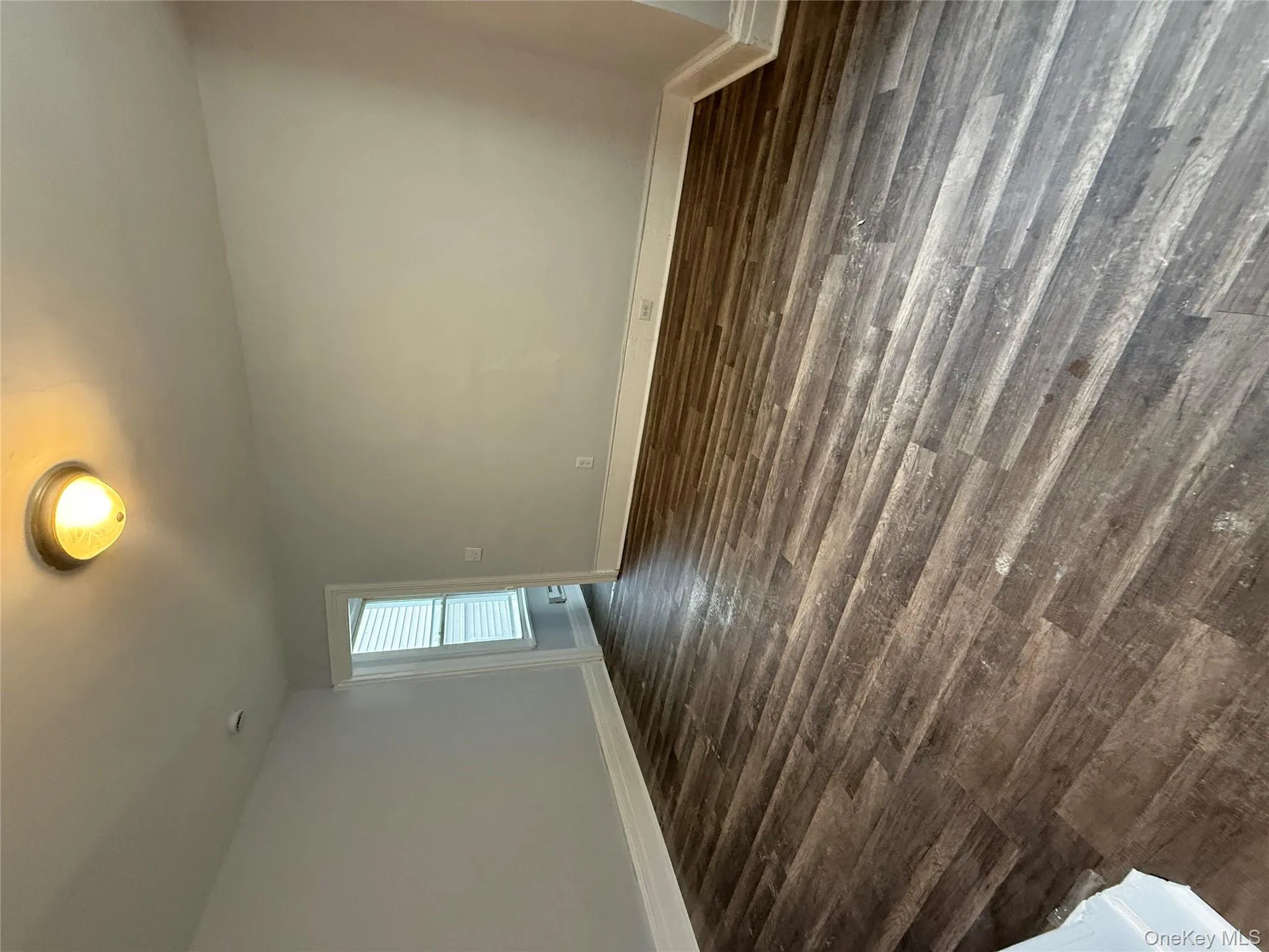 Unfurnished room featuring baseboards and dark wood finished floors Unfurnished room featuring baseboards and dark wood finished floors