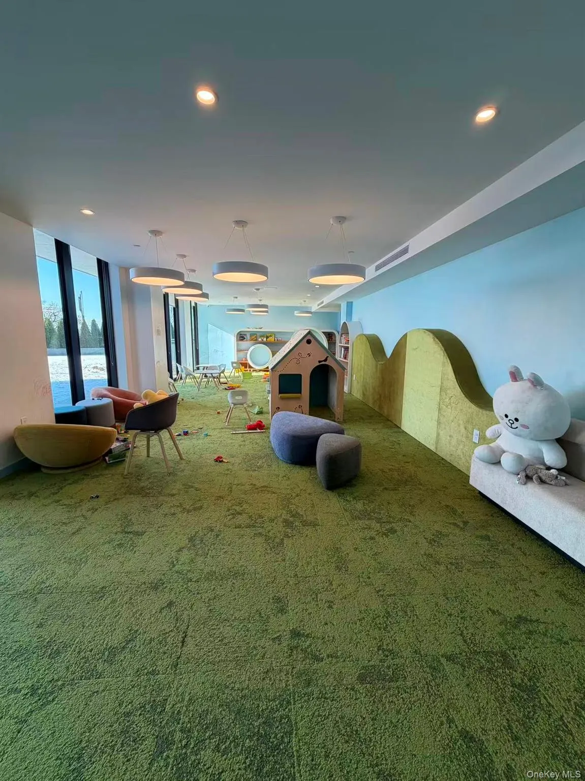 Misc room featuring recessed lighting, a wall of windows, and carpet floors Misc room featuring recessed lighting, a wall of windows, and carpet floors